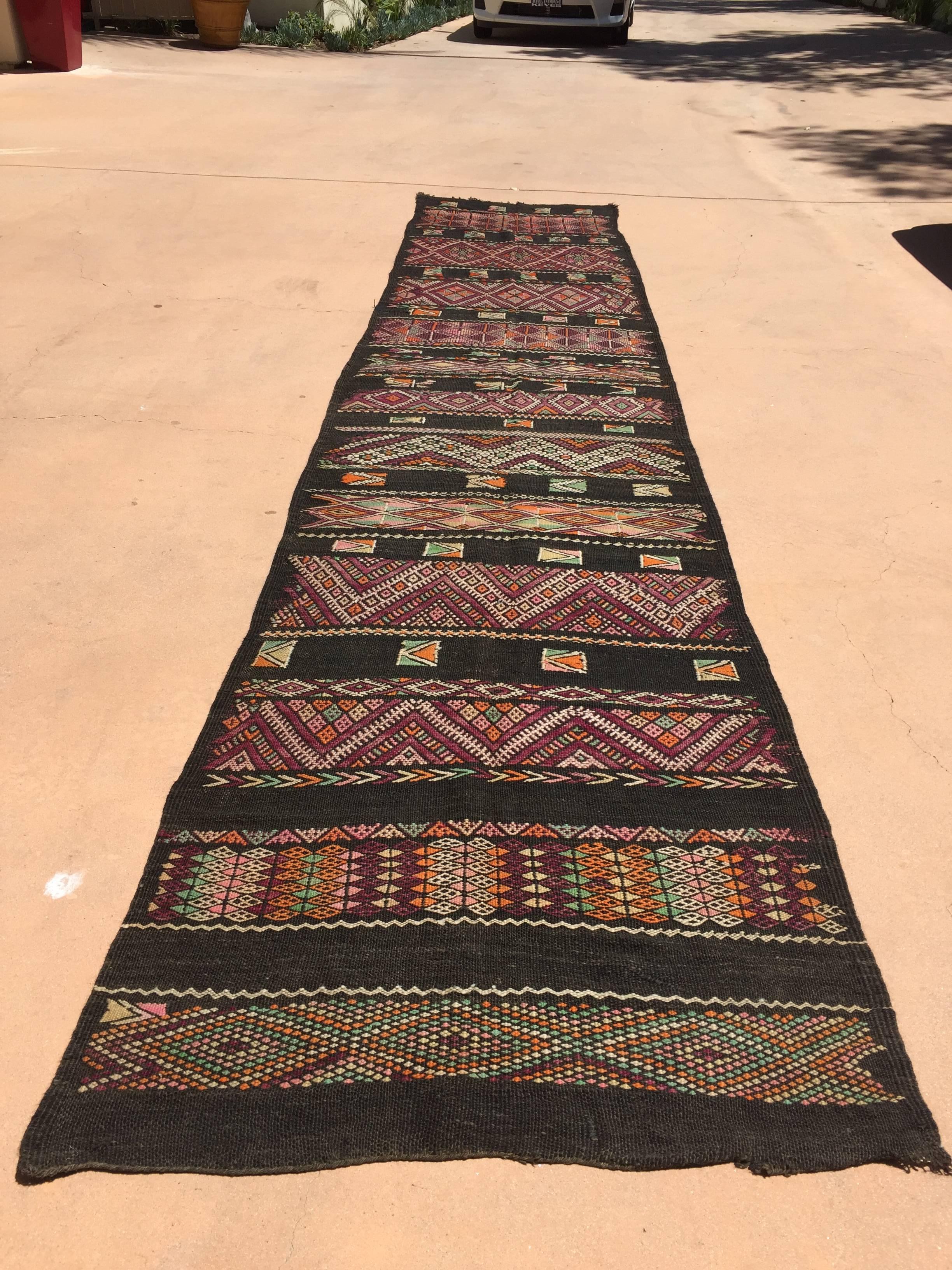 Vintage Moroccan Nomadic rug, black camel hair with wool and cotton embroidered geometrical Modernist designs.
Mid-Century African tribal rug very long runner.
Kilim flat-weave.
This rug was used for room separation in the Berber tents, those