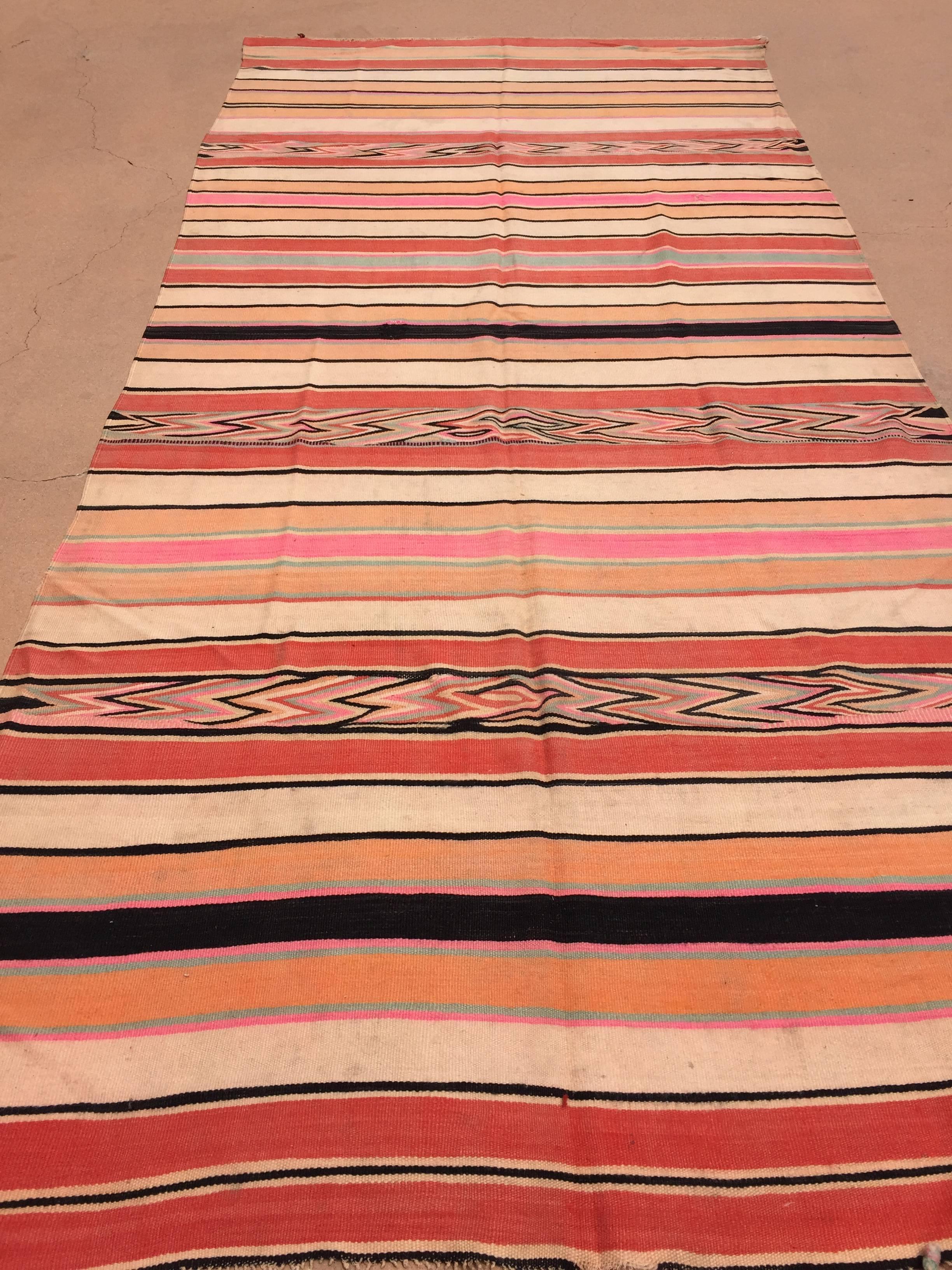 Authentic Vintage Moroccan flat-weave Kilim rug.Large size blanket textile vintage Moroccan rug, handwoven by Berber women in Morocco for their own use. This rug was made using flat-weave technique with linear pattern of alternating stripes in