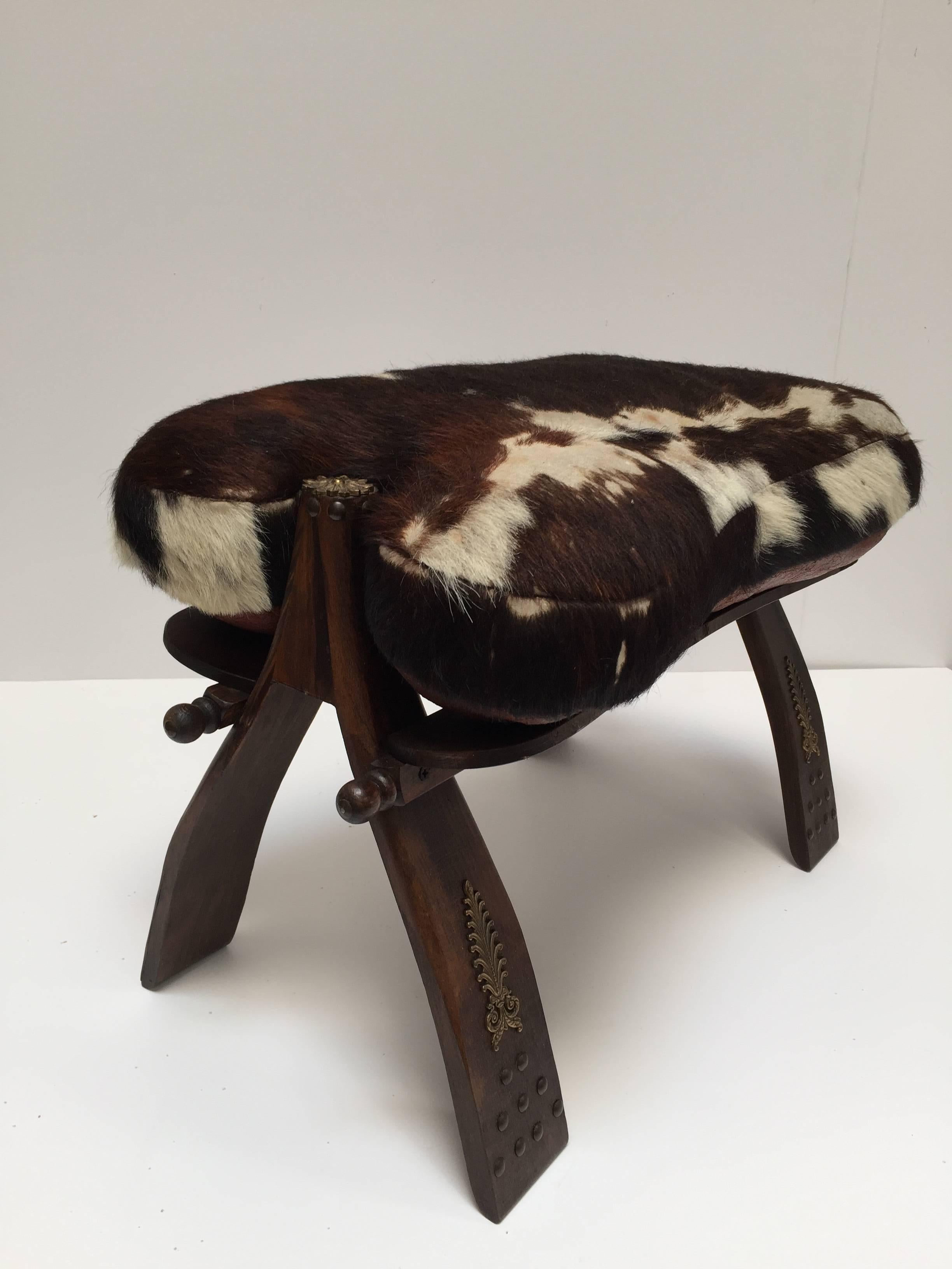 Tribal Pair of Camel Saddle Seat Footstools with Cowhide Cushions