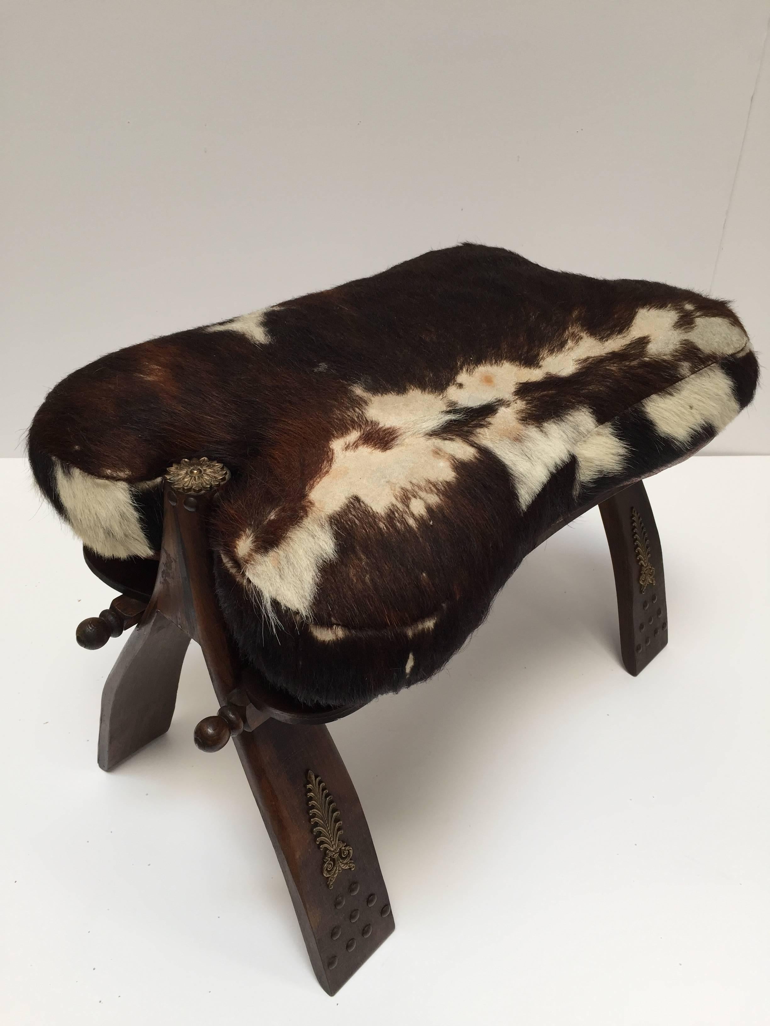 Hand-Carved Pair of Camel Saddle Seat Footstools with Cowhide Cushions