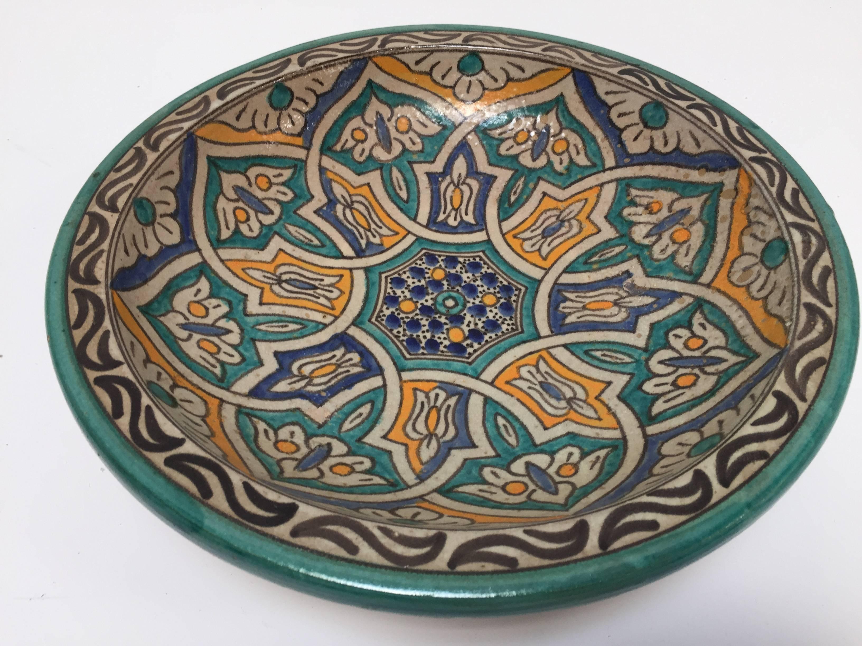 Large Moroccan ceramic bowl handcrafted in Fez by artisans.
Hand-painted ceramic from Fez Morocco.
This kind of Moorish Spanish style ceramic artwork could be found at the Alhambra palace in Granada Spain.
Turquoise, blue, safran yellow and ivory