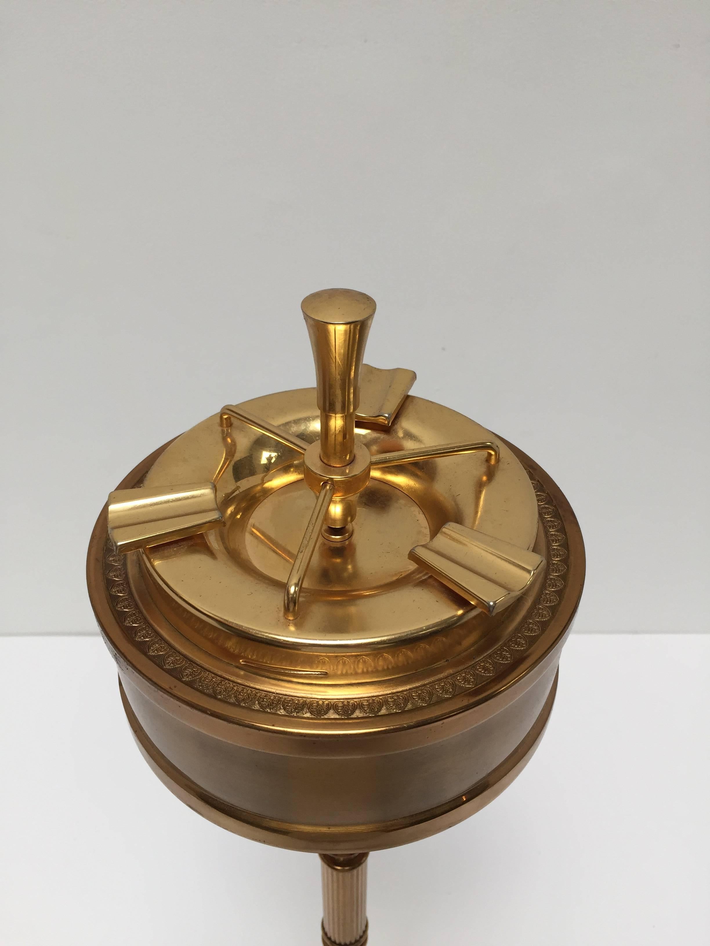 Stunning 1950s faux bamboo brass pillar ashtray by Maison Baguès. 
Excellent patina to brass. 
Center rod pushes down to release ash into lower basin. 
Great sculptural decorative ashtray stand.
Made in Italy.
Dimensions: 28