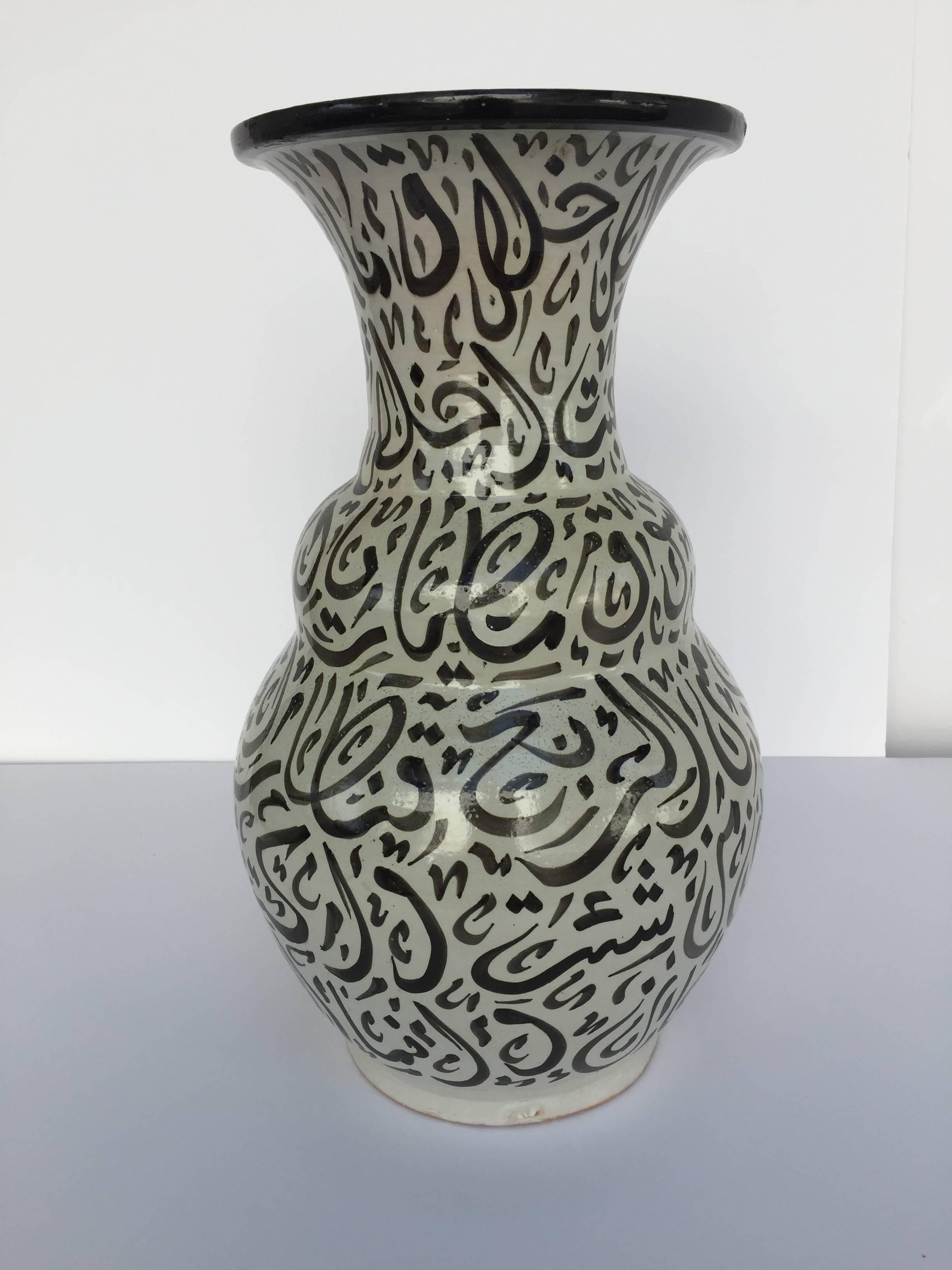 Large Moroccan glazed ceramic vase from Fez. 
Moorish style ceramic handcrafted and hand-painted with Arabic calligraphy writing.
This kind of Art Writing looks calligraphic is called Lettrism, it is a form of art that uses letters that are not