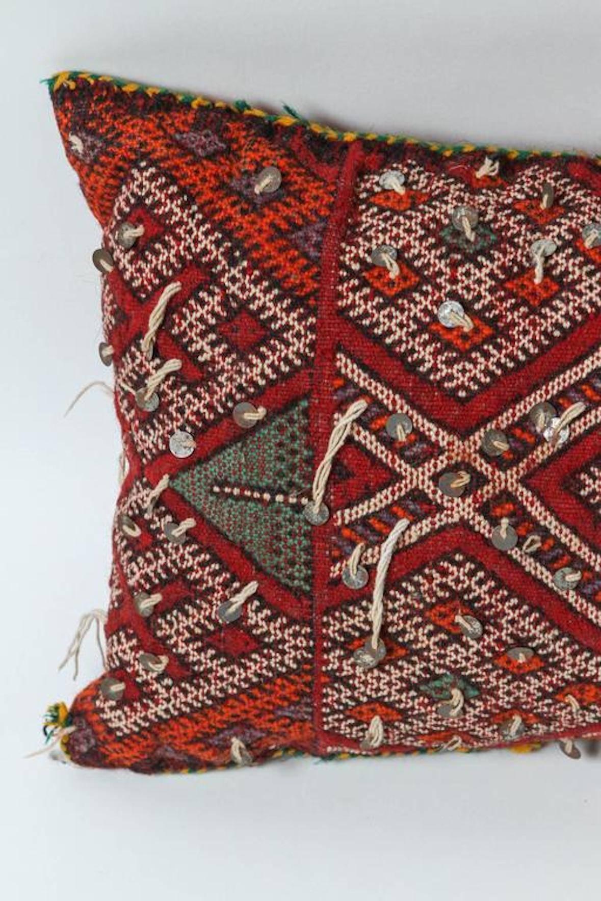 Moroccan handwoven tribal throw pillow made from vintage rug.
The front and the back are made from a different rug, front is more elaborate and back is striped.
Handwoven by Berber women from the Middle Atlas in Morocco.
Geometric designs in red,