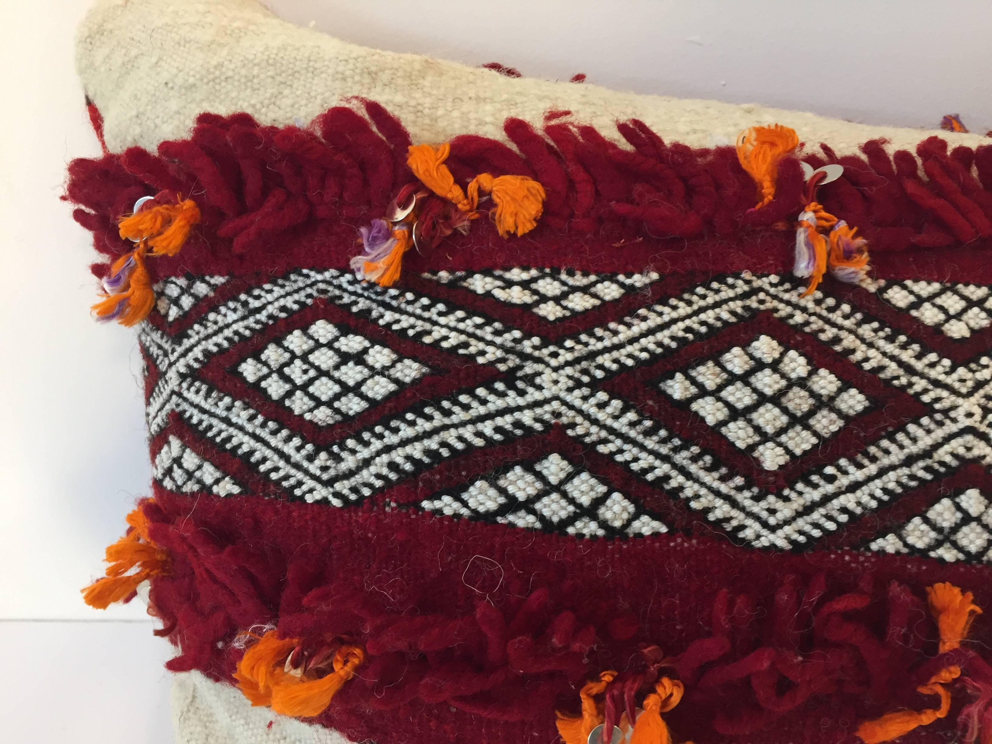 Moroccan Berber pillow white and red with geometric tribal designs.
Handwoven tribal throw pillow made from a vintage flat-weave rug. 
Made from Tribal Moroccan rug, he front and the back are made from a different Moroccan carpet, the front is more