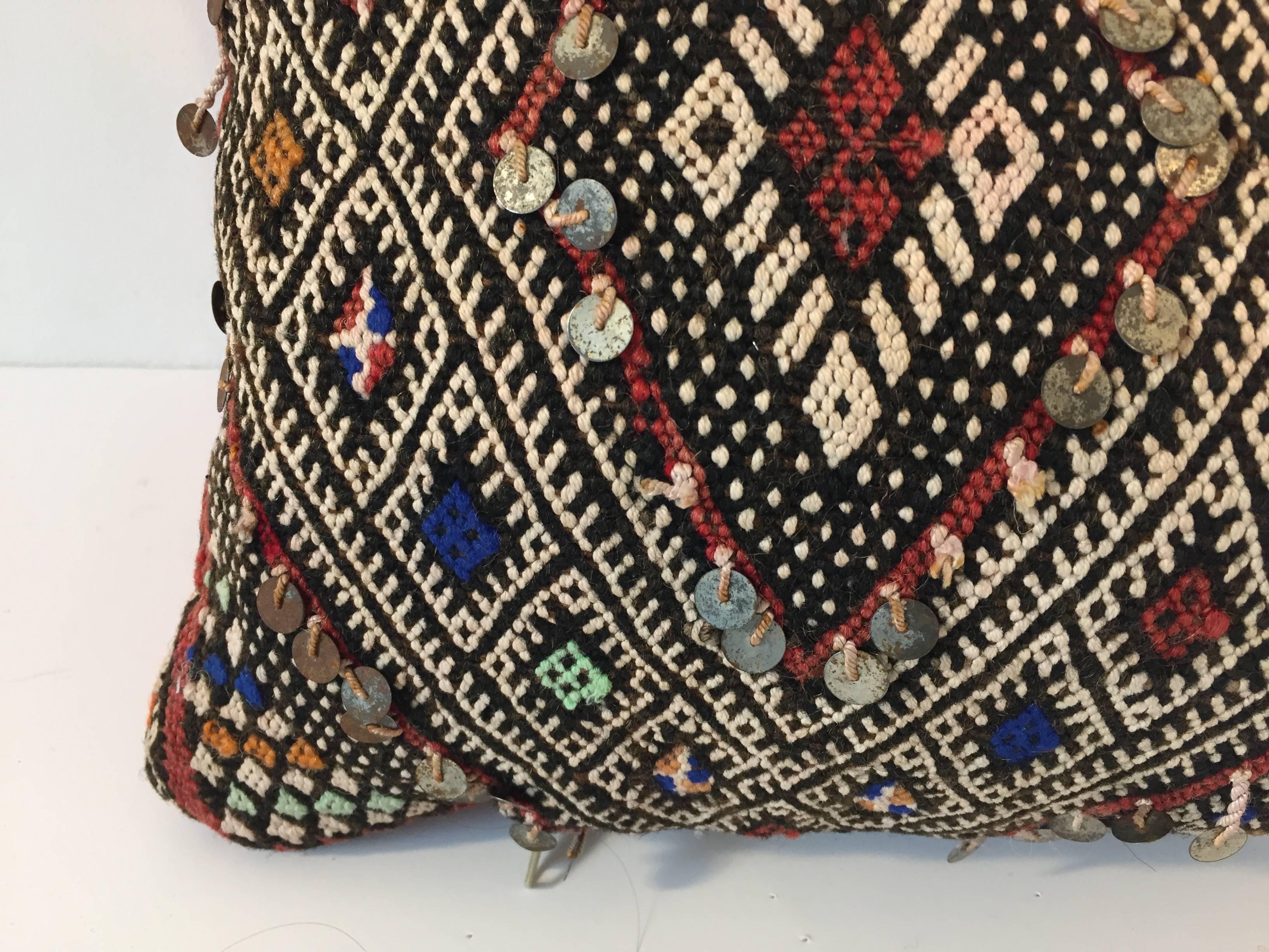 Moroccan Berber pillow red with geometric tribal diamond designs.
Handwoven tribal throw pillow made from a vintage flat-weave rug. 
The front and the back are made from a different rug, front is more elaborate and back is burnt orange.
