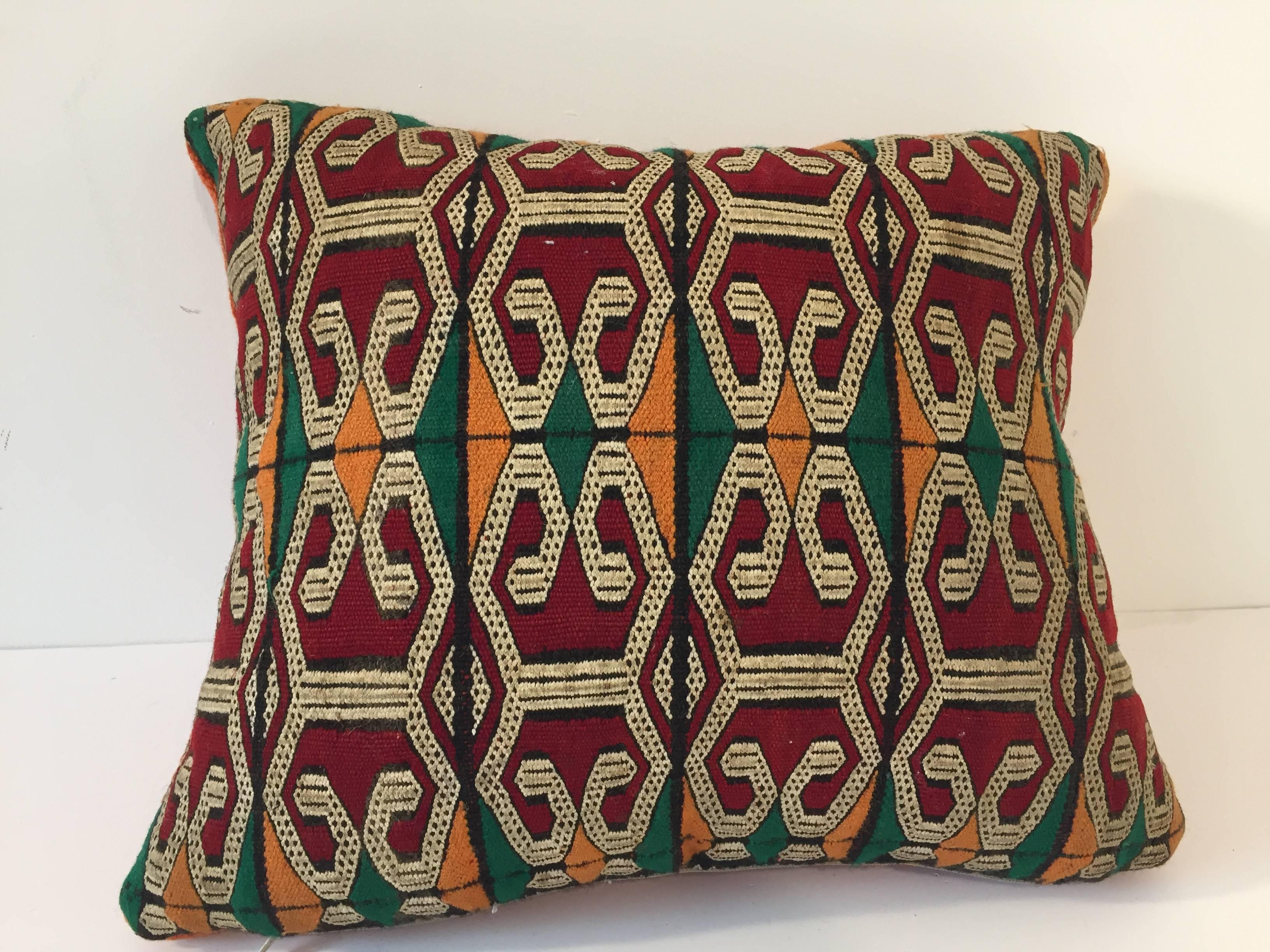 Moroccan Berber handwoven tribal throw pillow made from a vintage flat-weave rug.
The front and the back are made from a different rug, front is more elaborate and back is more plain.
Geometric African tribal designs in red, white and black and