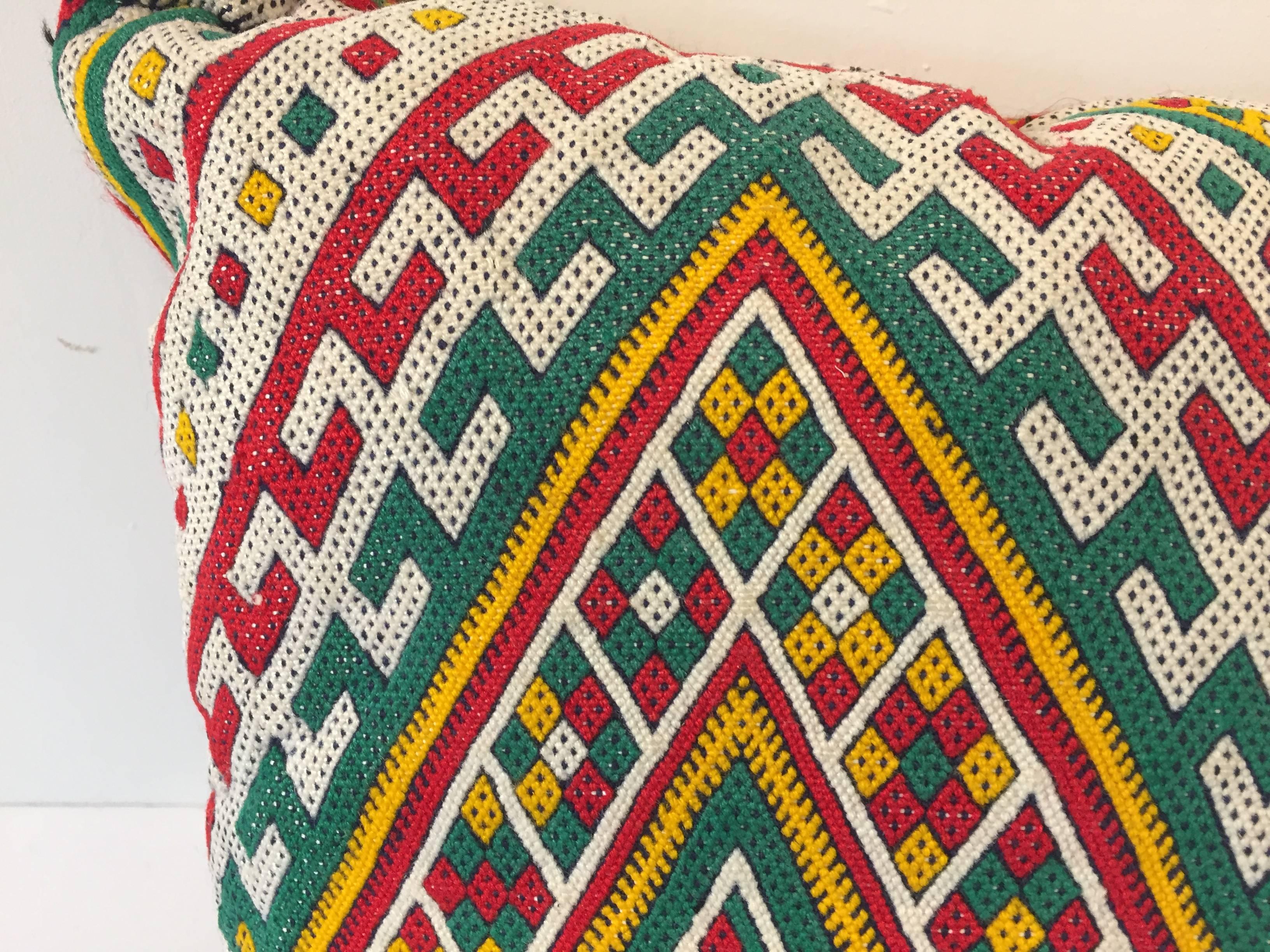 Moroccan Berber handwoven tribal throw pillow made from a vintage flat-weave rug.
The front and the back are made from a different rug, front is more elaborate and back is more plain.
Geometric African tribal designs in red, white and black and
