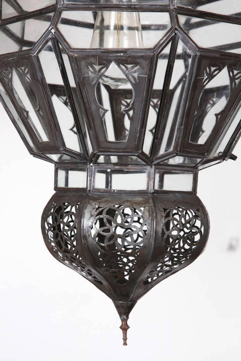 Moroccan Moorish clear glass with intricate metal filigree hanging chandelier. 
Delicately handcrafted by artisans in Morocco. 
Bronze metal color finish and clear glass. 
This Moorish Harem pendant chandelier will add style to any Moroccan or