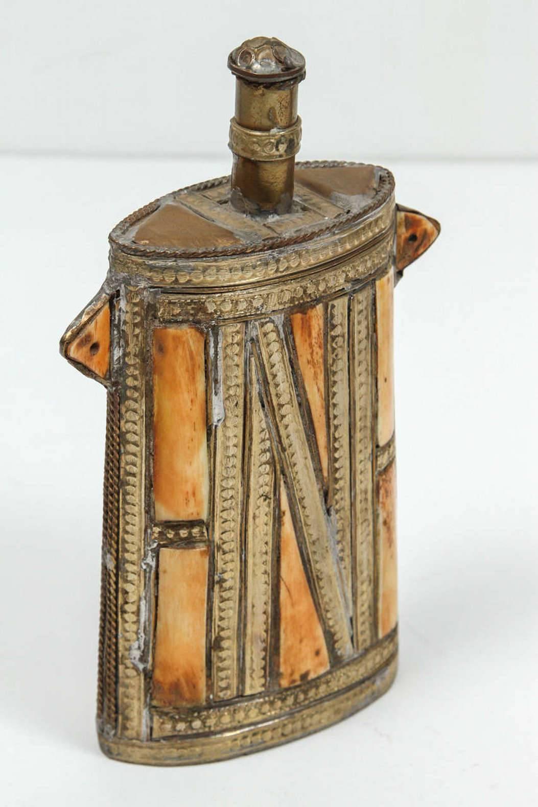 Great decorative Moroccan Tribal  flask..
African decorative brass with front richly decorated with embossed brass and overlay.
The valve stem turns and open.
Truly a conversation museum piece of Moroccan decorative brass tribal Folk Art.