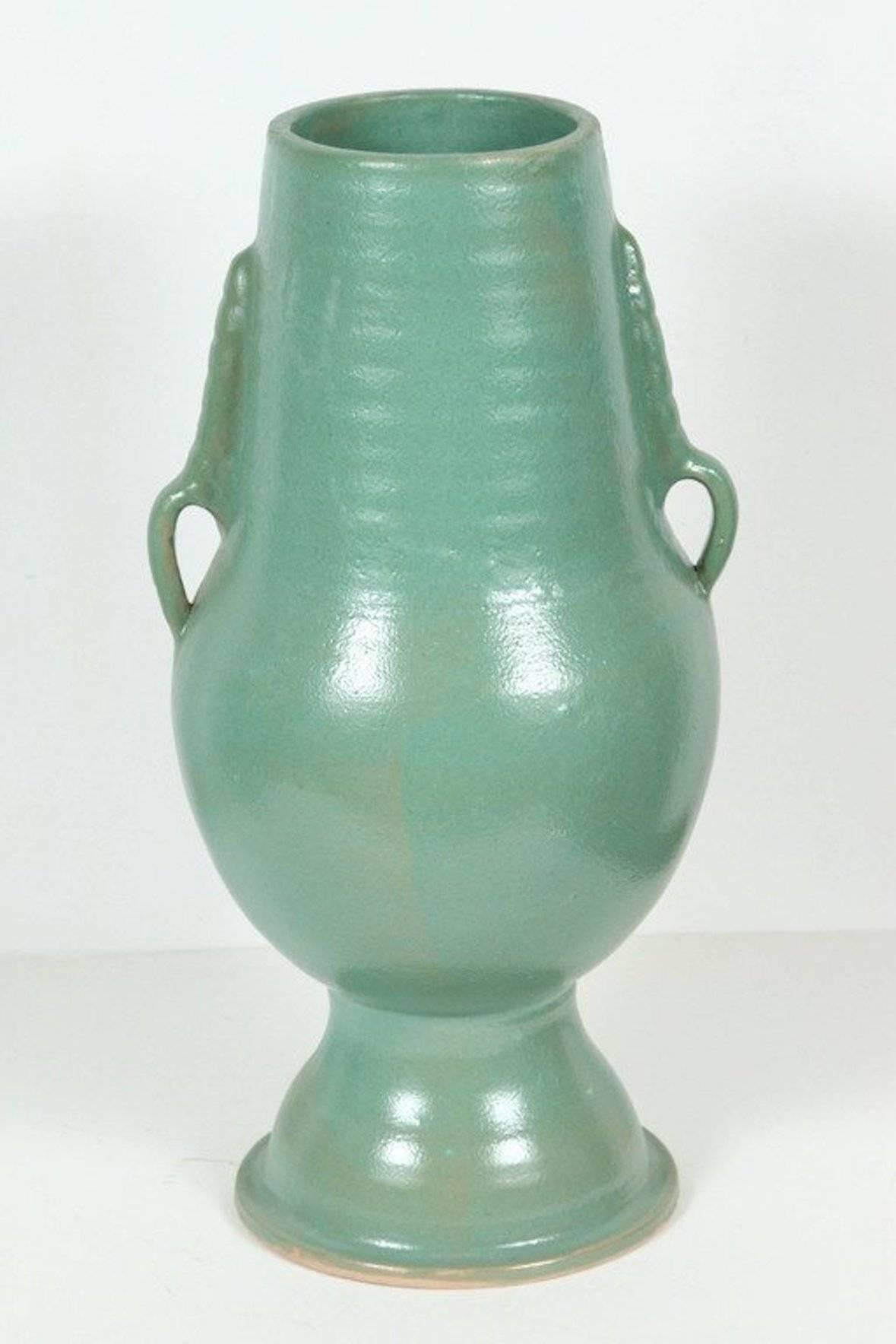 Footed Moroccan turquoise (teal) color handcrafted ceramic vase with handle.
Great modern form and elegant lines.
Work with modern or Classic interiors.
Size: 22 in H.
12 in Diameter for the widest part.
Top: 6.25 in. D.
Bottom diameter : 8.5