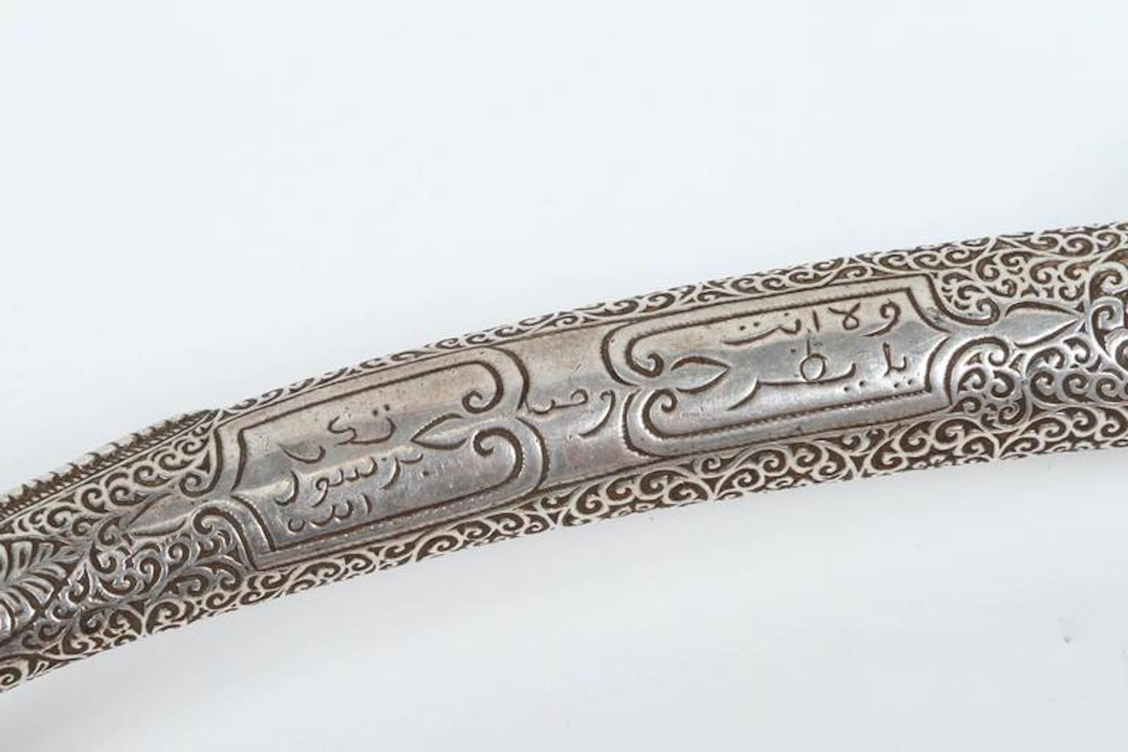 Moroccan sterling silver dagger with filigree designs handcrafted by artisans in Morocco, very fine quality craftsmanship with a bone grip engraved with Moroccan silver and chiseled in scrolling foliage.
Double edge blade with maker marks.
The