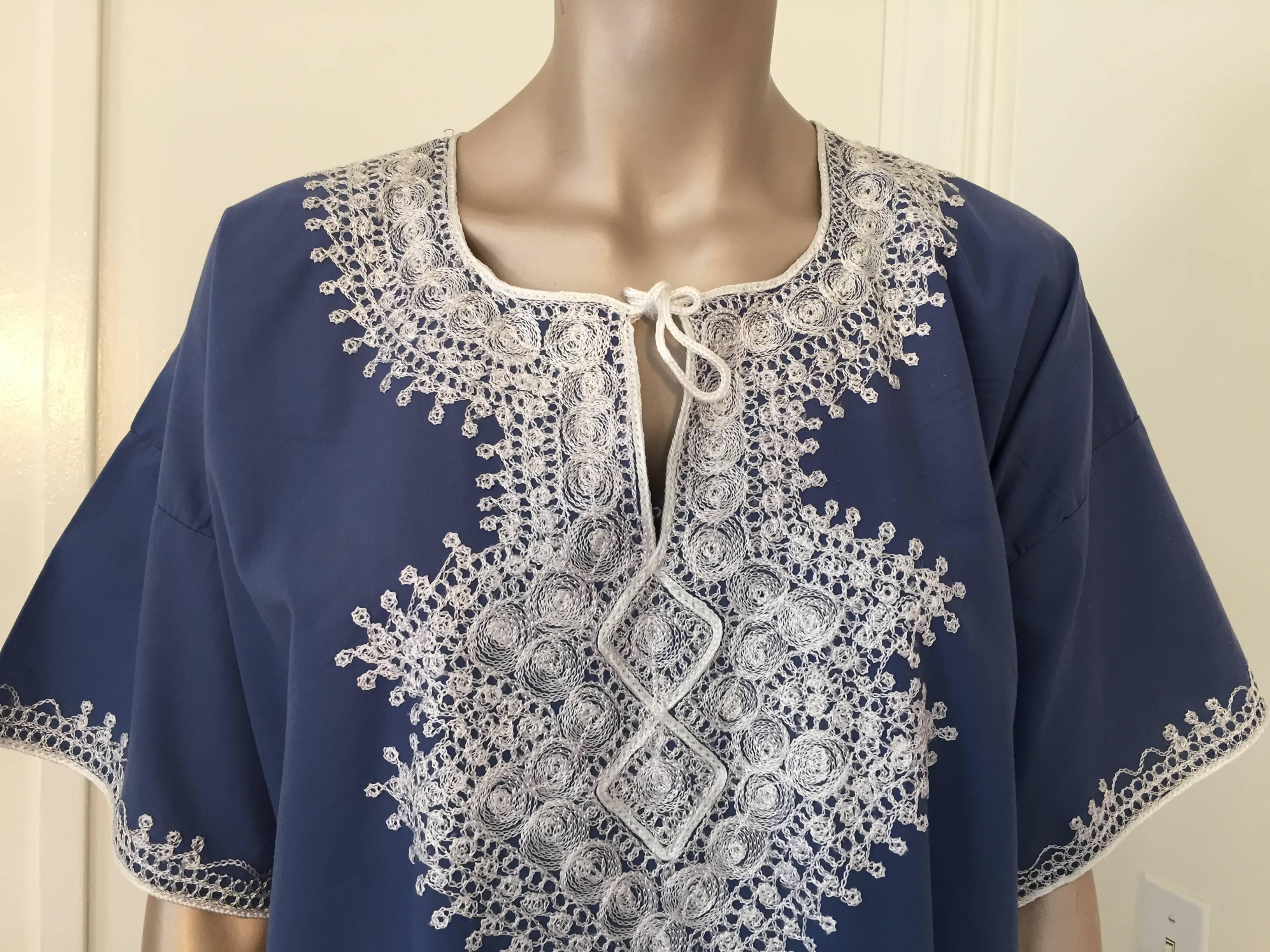 Bohemian Moroccan caftan blue color embroidered with white threads.
circa 1980s.
This long maxi dress cotton summer kaftan is embroidered with traditional Moorish designs.
The kaftan features a traditional neckline, with side slits and embellished