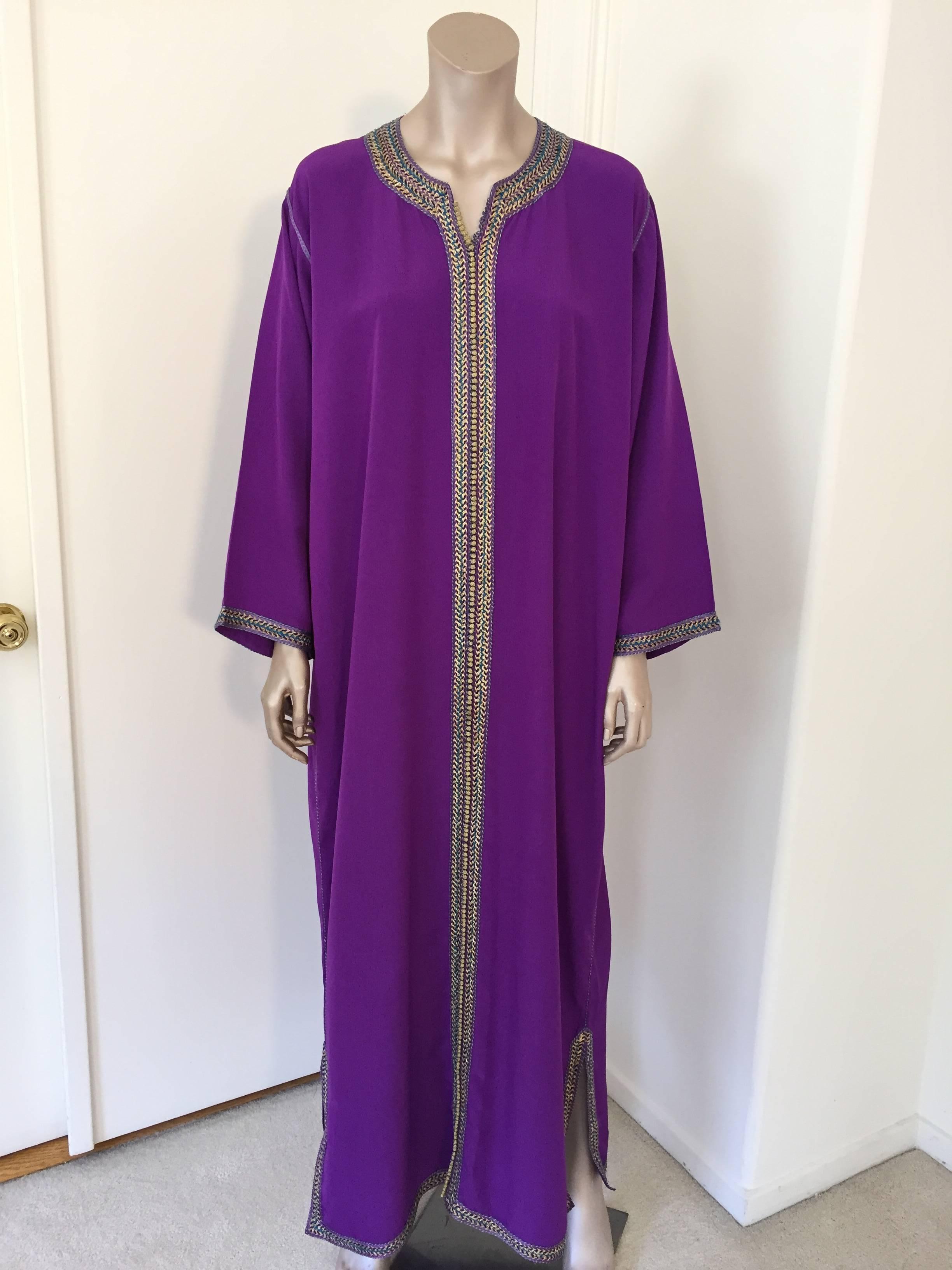 Elegant Moroccan caftan purple violet color embroidered with gold trim,
circa 1970s.
This long maxi dress kaftan is embroidered and embellished entirely by hand.
One of a kind evening Moroccan Middle Eastern gown.
The kaftan features a traditional