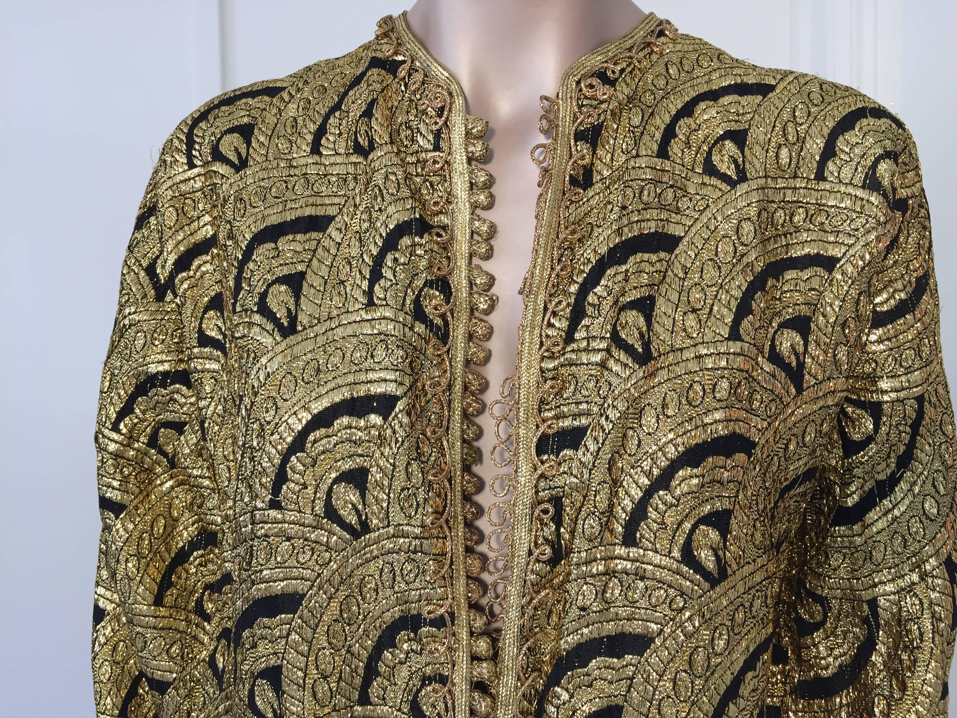 Elegant Moroccan caftan gold and black Art Deco style brocade silk fabric,
circa 1960s.
This kaftan is embroidered and embellished entirely by hand.
One of a kind evening Moroccan Middle Eastern vest.
The kaftan features a traditional neckline and