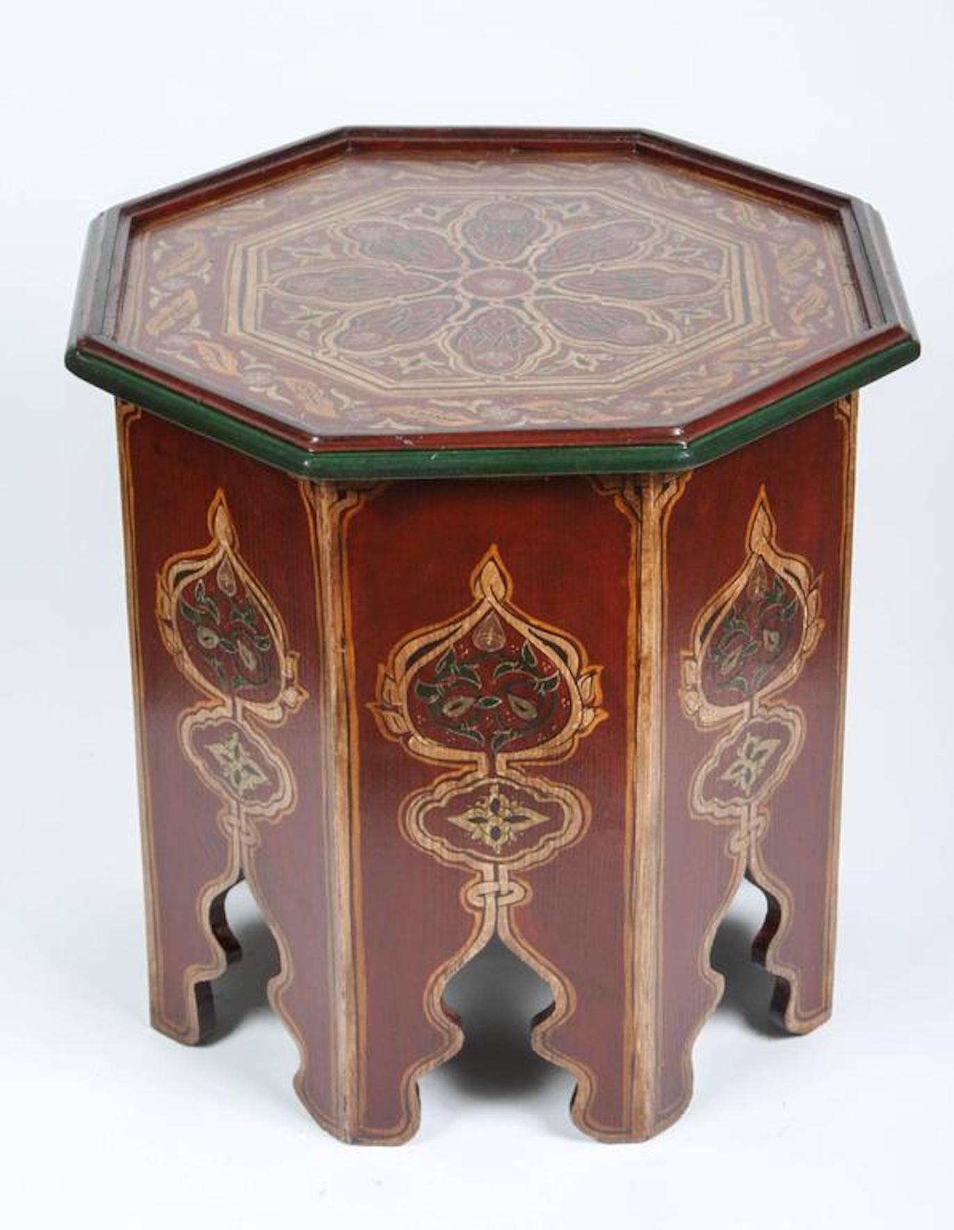 Moroccan hand-painted side table with Moorish designs.
 Maroon background with multicolored floral and geometric designs. 
Very fine Moorish artwork on an octagonal shape base with hand cut Moorish arches on each side. 
You can use them as