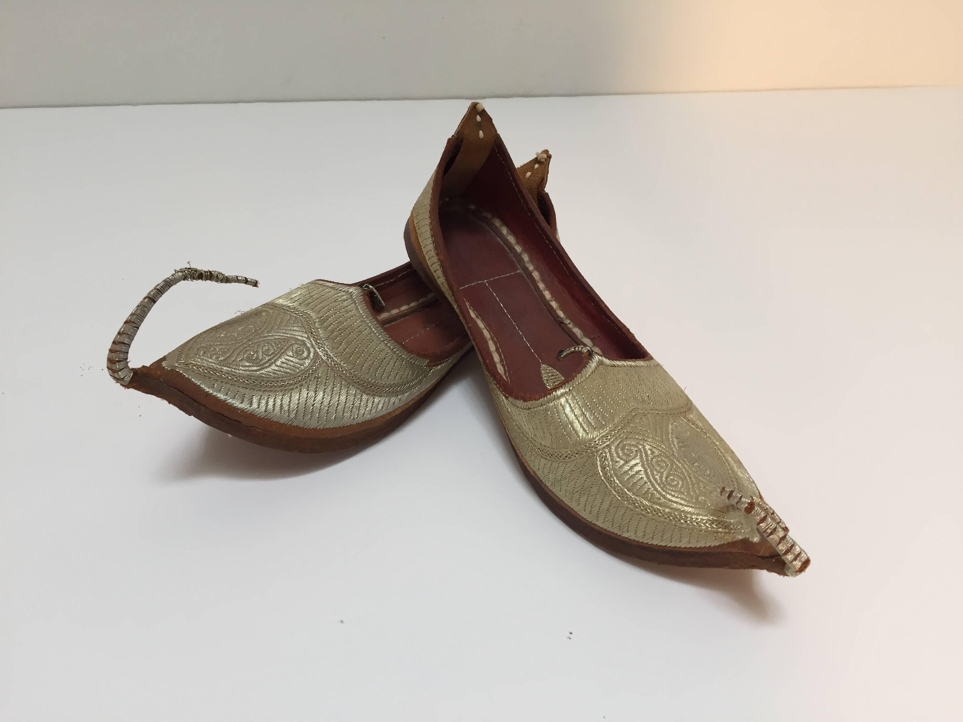 Amazing vintage Middle Eastern Moorish gold embroidered shoes.
Ceremonial wedding slippers, embroidered with gold thread. 
Aladdin, Ali Baba Arabic genie style with gold and leather sole and classic curled toe amazing to use as decorative objects or