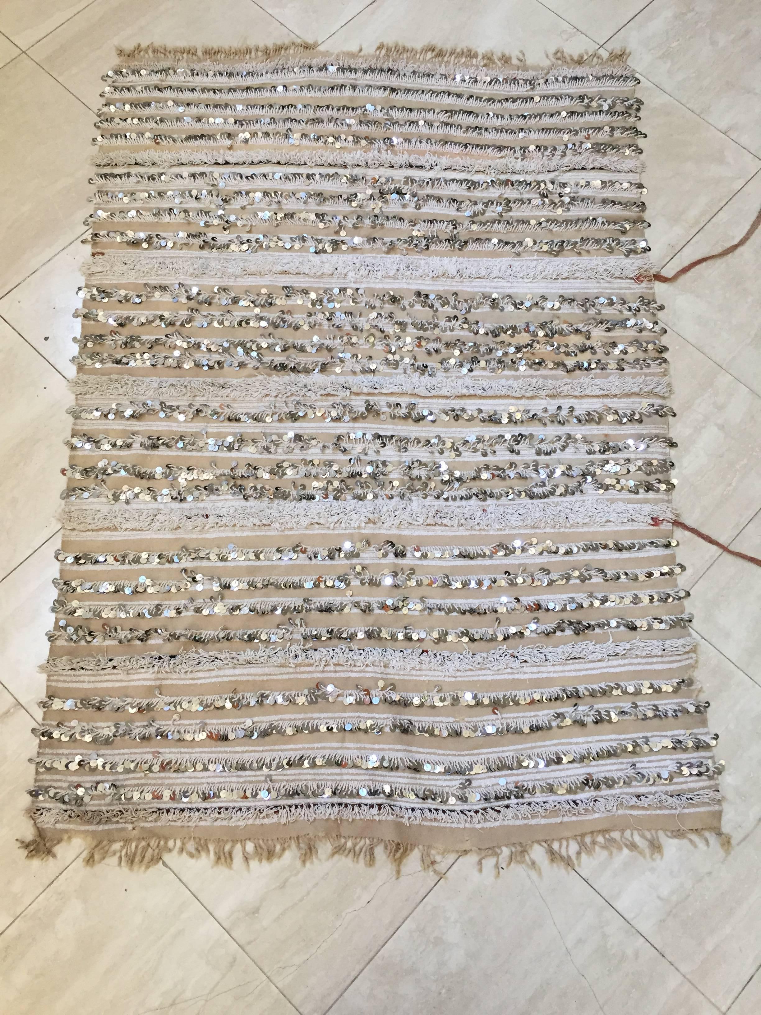 large vintage original tribal Moroccan wedding Berber women shawl, blanket, throw.
The Zaiane tribal shawls incorporate quantities of sequins in their design to achieve an impressive decorative effect on the alternate stripes of wool and cotton