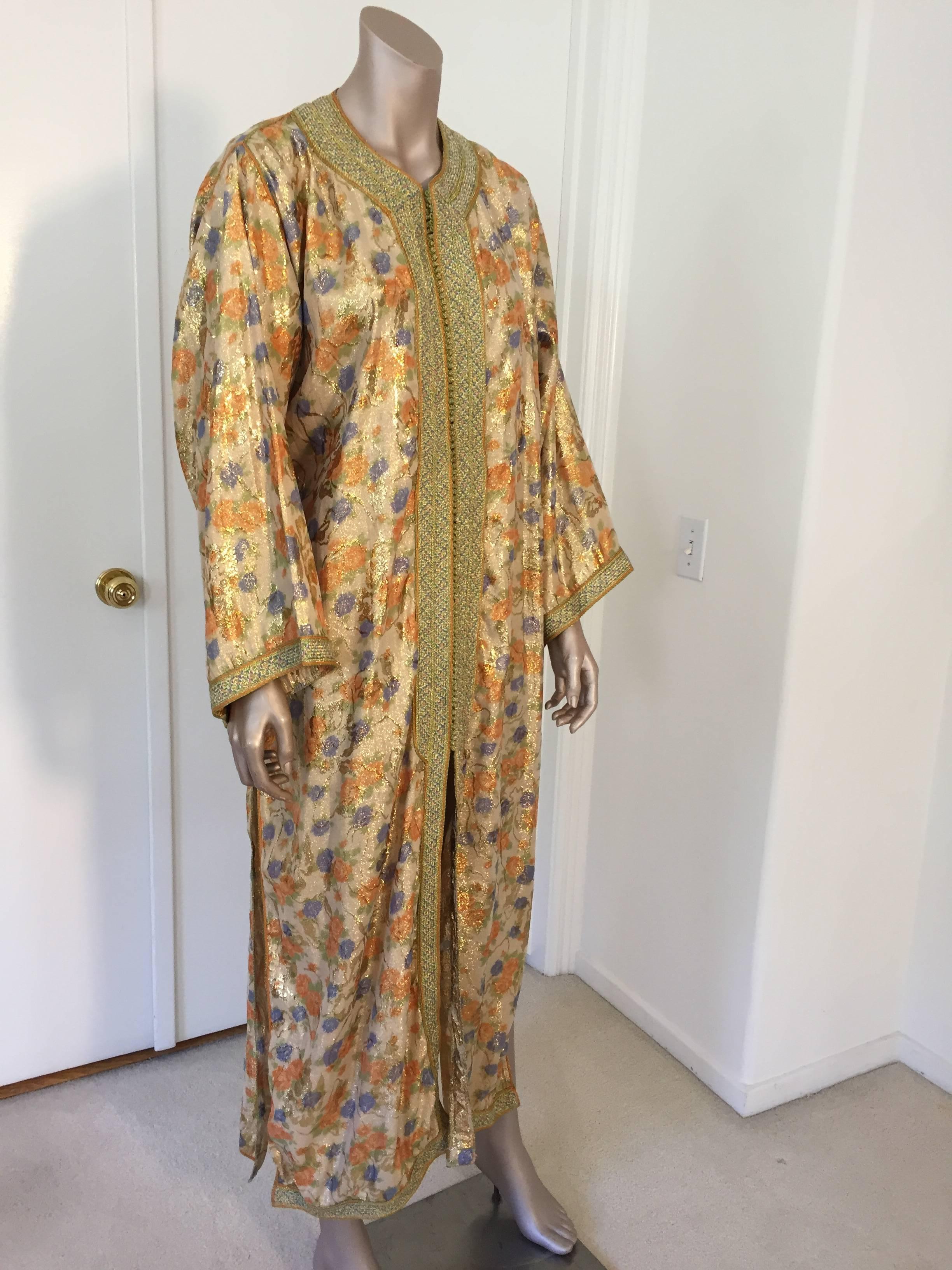 Elegant Moroccan caftan floral brocade embroidered with gold trim, circa 1970s. 
This long maxi dress kaftan is embroidered and embellished entirely by hand. 
One of a kind evening Moroccan Middle Eastern hostess gown. 
The kaftan gown features a