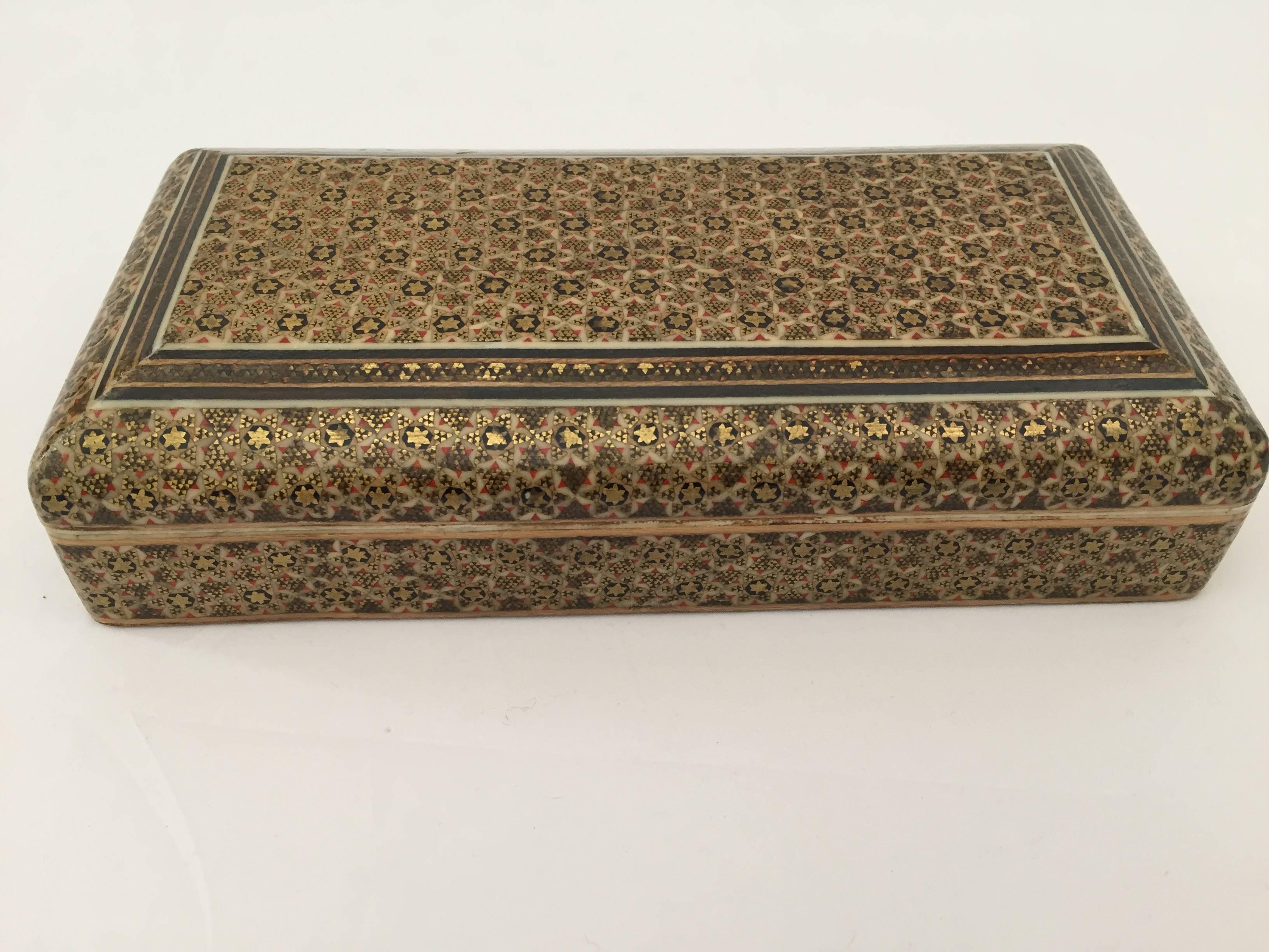 Handcrafted Khatam wooden box with very delicate micro mosaic marquetry from the ancient Persian technique of inlaying from arrangements of so many delicate pieces of wood, camel bones, precious wood, and delicate miniatures paintings.
This