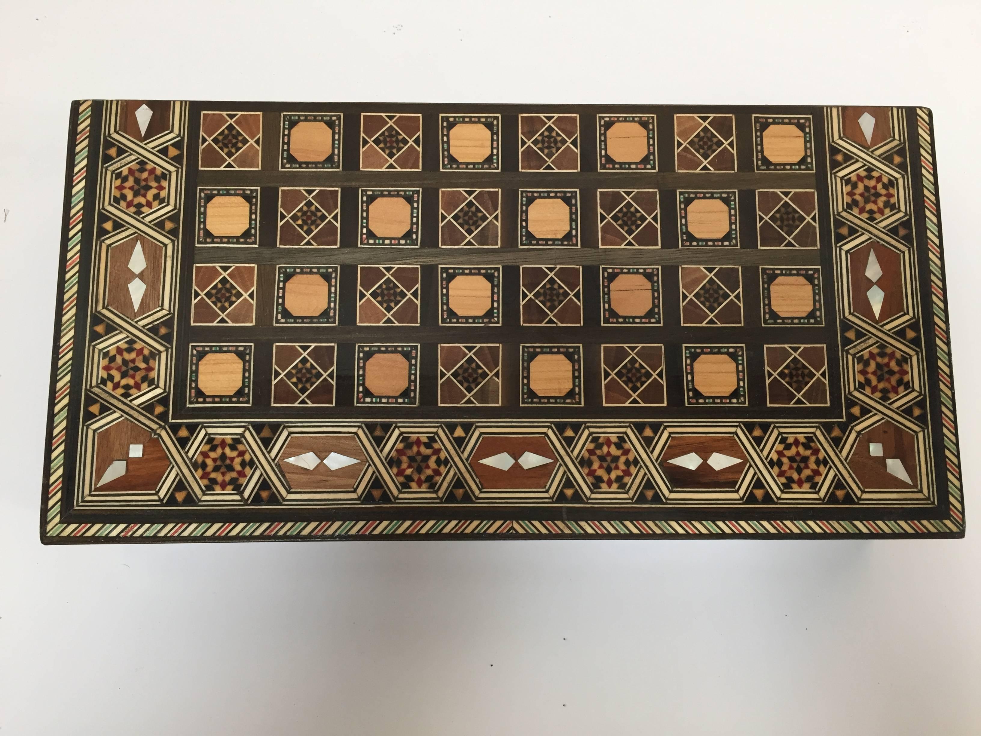 Syrian inlaid marquetry mosaic backgammon and chess game box.
Amazing craftsmanship the intricate marquetry fruitwood in mosaic Moorish geometric pattern and mother-of-pearl inlay makes it a true work of art.
Handcrafted in the Middle East,