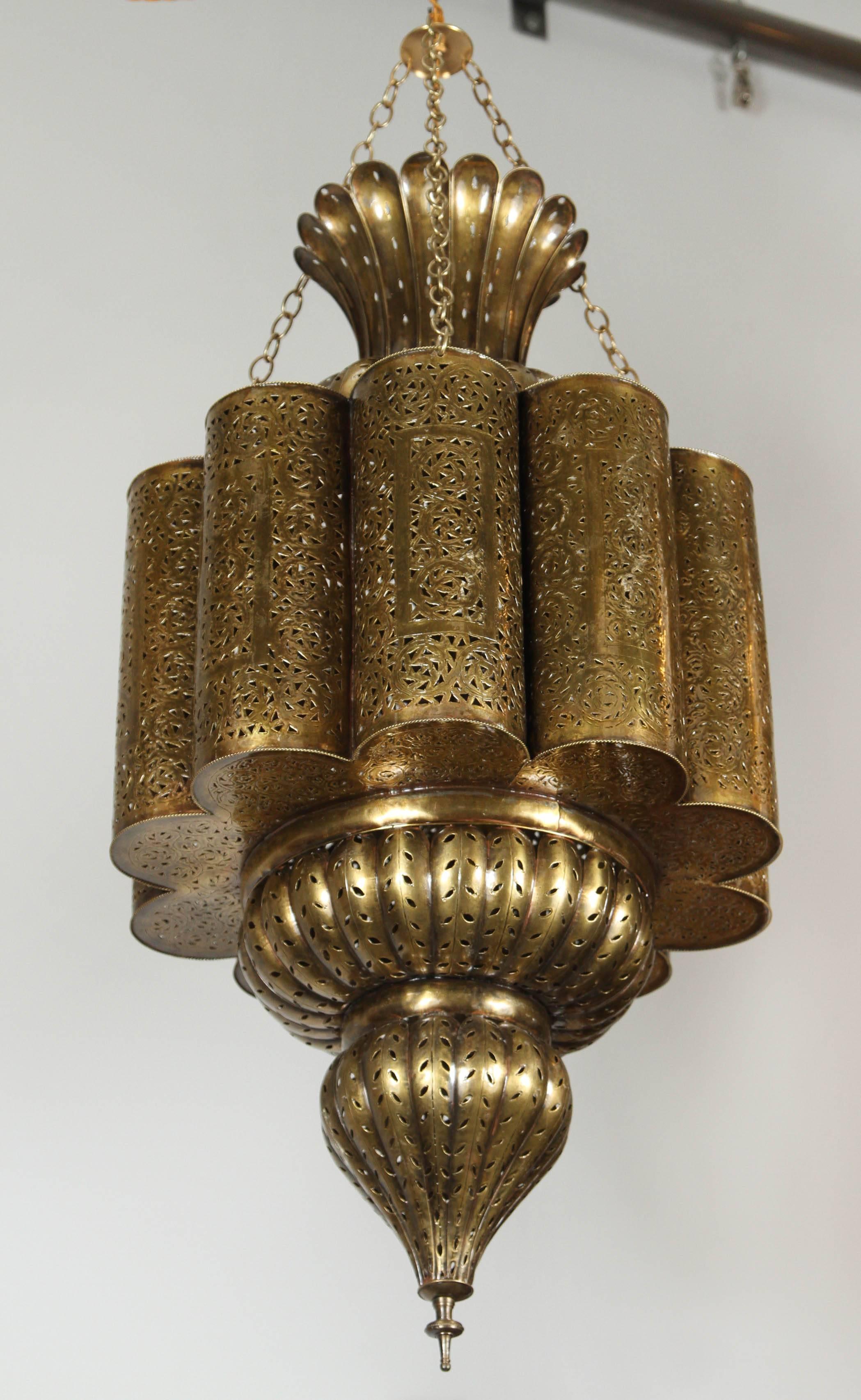 Spectacular, exquisite pierced brass Moorish Moroccan chandelier.
 This exquisite light fixture is handcrafted and chiseled with fine filigree Islamic designs. Moroccan bronze patina finish, hand cut and hand-chased brass.
Brass body is 31