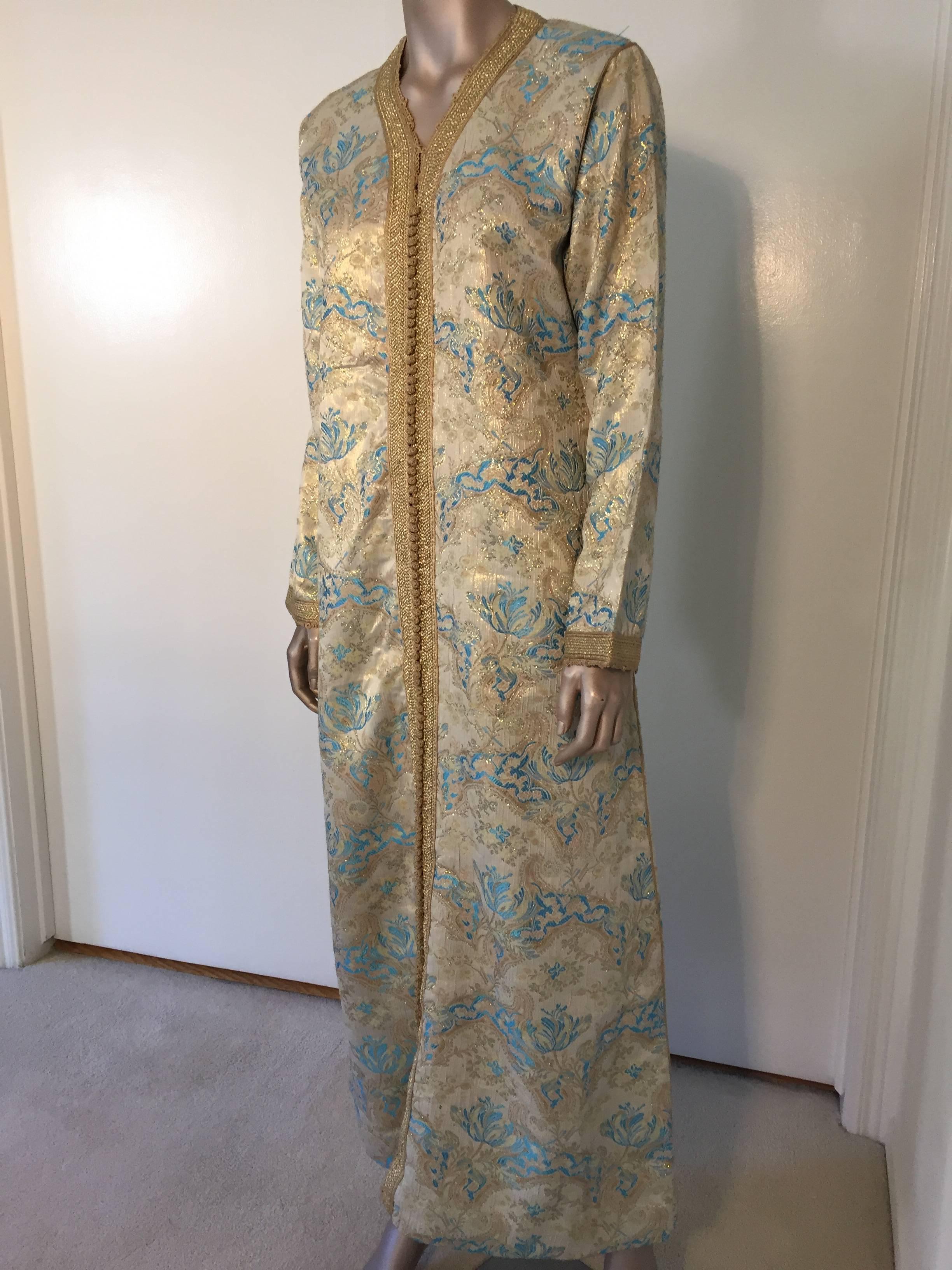 Elegant Moroccan caftan gold and aquamarine blue metallic gorgeous vintage hostess gown.
 Floral multi-colored brocade Kaftan circa 1970s.
Exotic oriental floral long maxi caftan dress with long sleeves in shimmering brocade gold and aquamarine blue