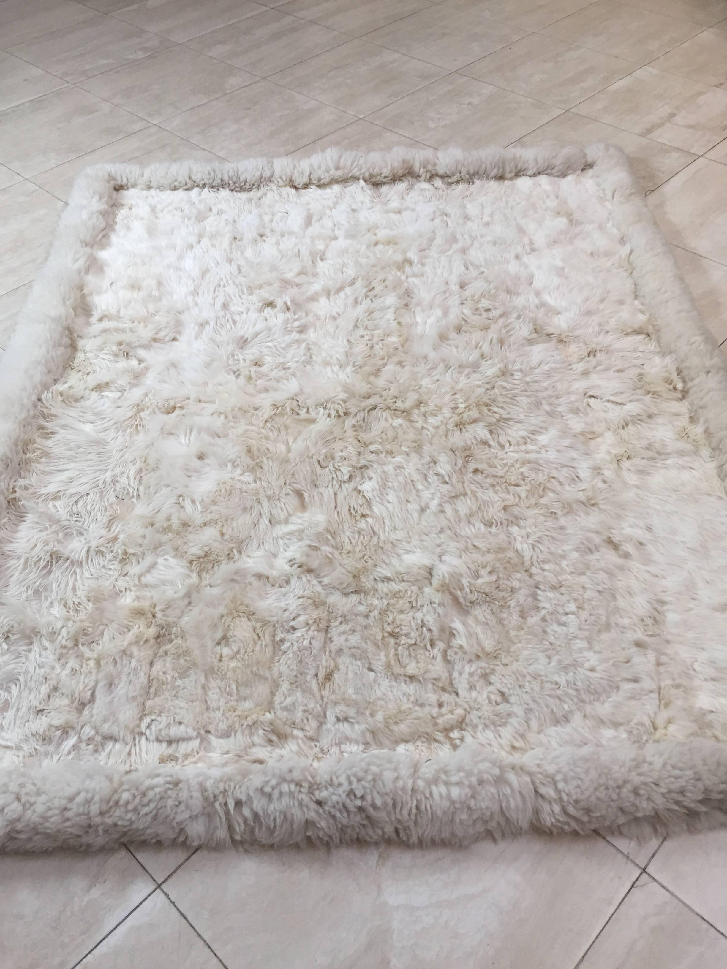 Shaggy white wild sheep skin bed throw or rug.
Quilted from pieces of fluffy soft sheep skin and sewn together.
New Zealand.
Natural ivory white sheep color.