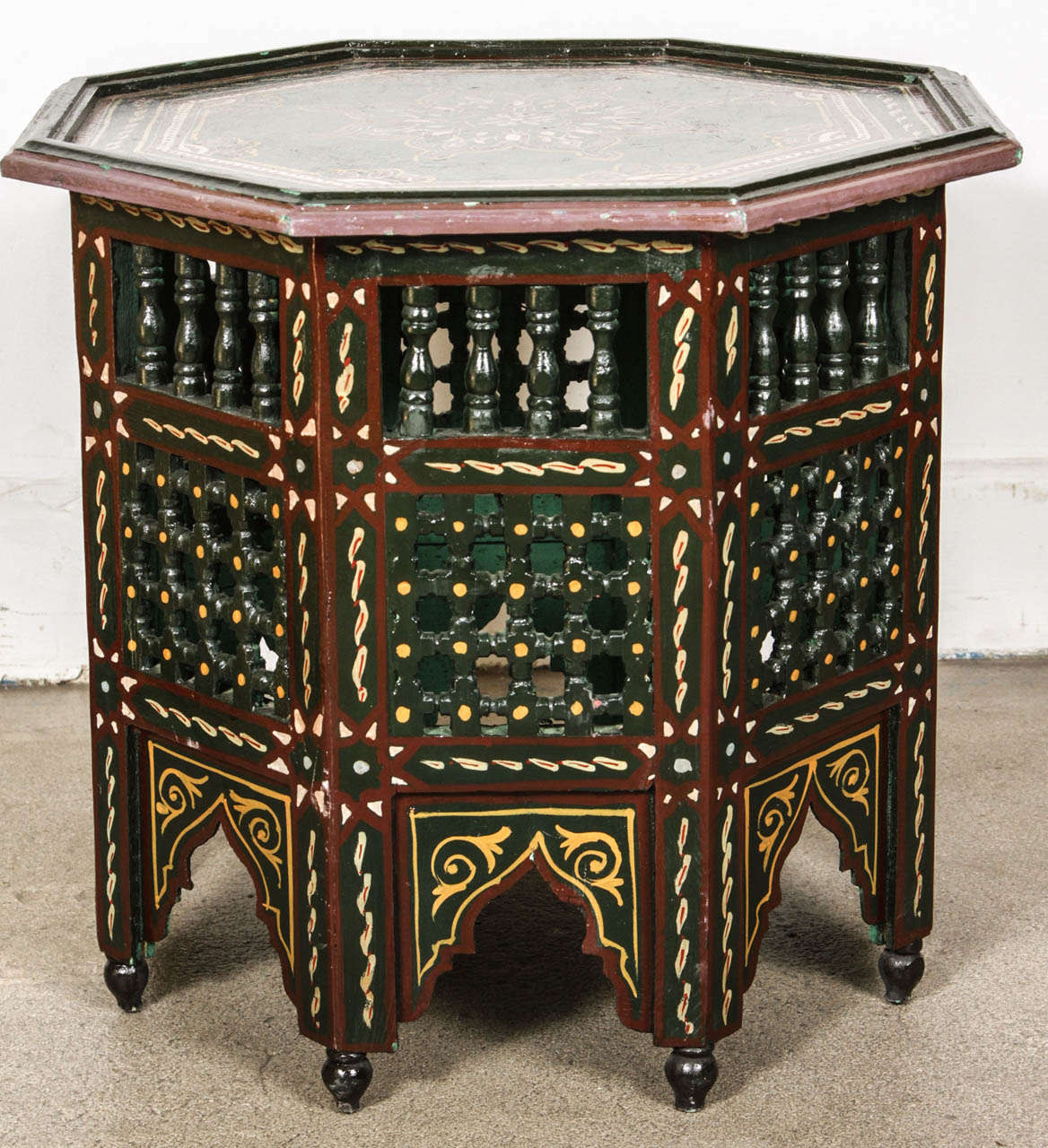 Pair of Moroccan colorful hand-painted dark green side table with Moorish design and open fret mousharabie work on sides.
Dark green background with multicolored floral top and geometric designs.
Very fine wood artwork on an octagonal shape with