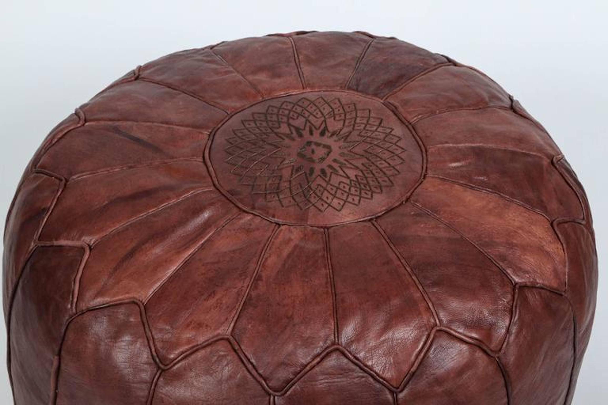 Pair of large vintage round Moroccan leather poufs, handcrafted in dark chocolate brown camel leather.
Hand tooled and embroidered leather stools on the top with the Moorish star by Moroccan artisans in Marrakech.
Nice patina.
Multiple available
