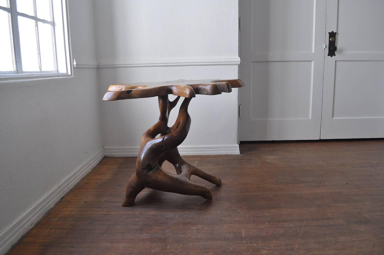 Exquisite natural organic form side table in teak. The base has the anamorphic essence of Henry Moore sculptures.