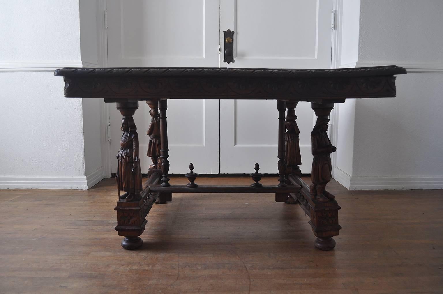 Exquisite late Victorian dining table with stretcher base and full carved figural legs.