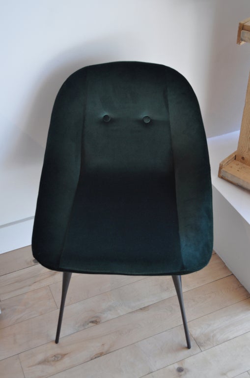 Green velvet upholstered dining chair with two button- tufted back detail on delicately sculpted bronze metal legs. Made to order and available in various standard fabric and leather upholstery options. Various metal finish options available for the