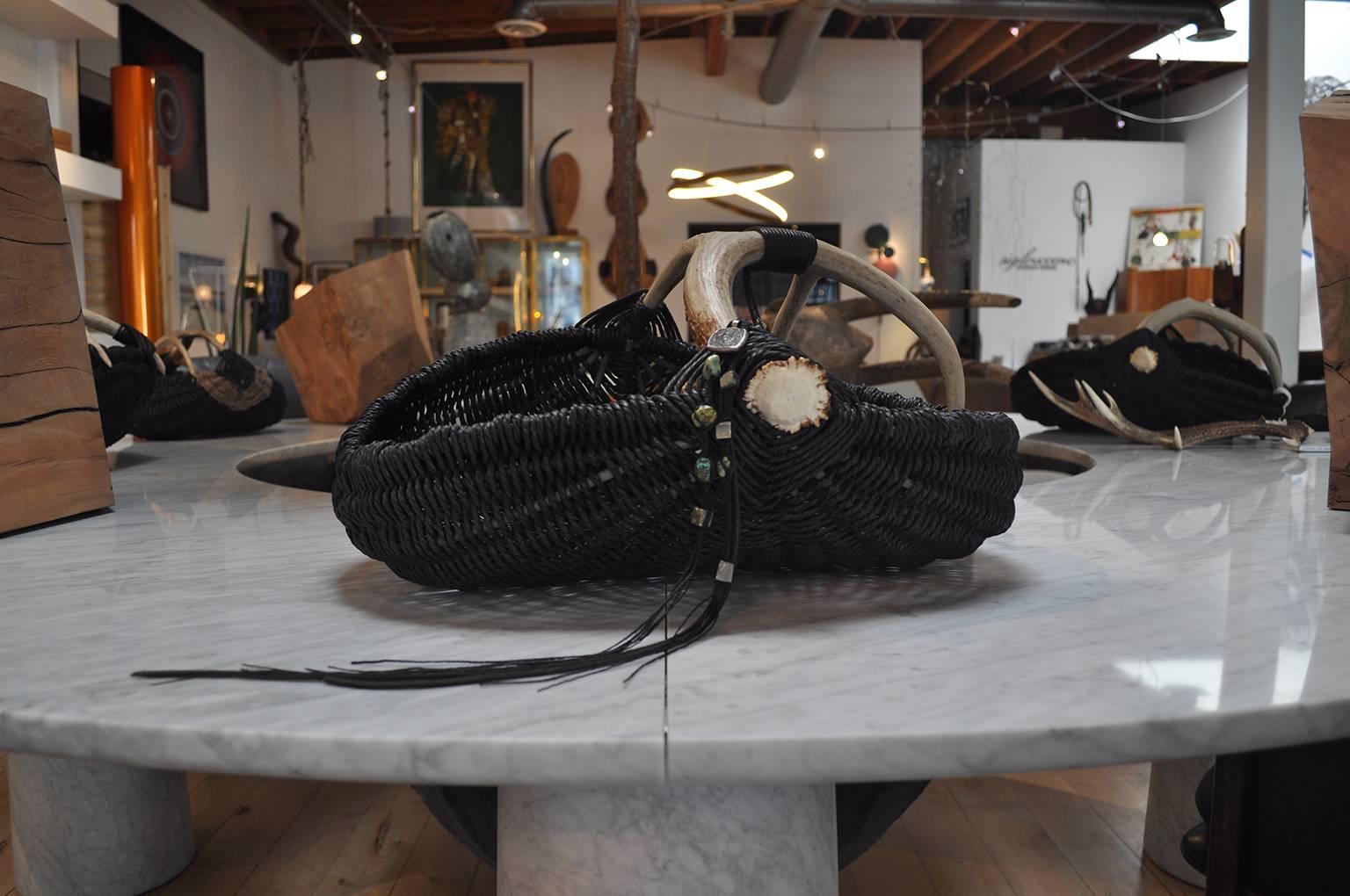 This large scale hand-made, custom, shed deer antler, reed and Danish paper rope basket, featuring leather and antique turquoise, pyrite, and an ancient Byzantine era coin wrapped in sterling silver, is made by Los Angeles based Artist and Designer,