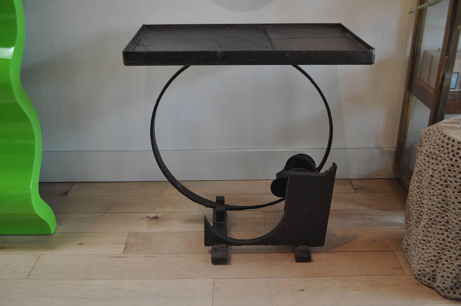 Exquisite hand welded assemblage brutalist table with grey stone table top inset.