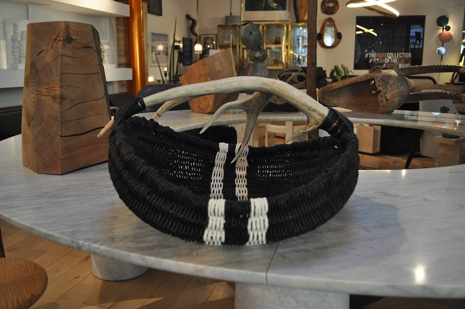 This large scale hand-made, custom, shed deer antler, reed and black and white Danish paper rope basket, is made by Los Angeles based Artist and Designer, Dax Savage. Having learned the art of antler basket weaving from his mother, Savages’ timeless