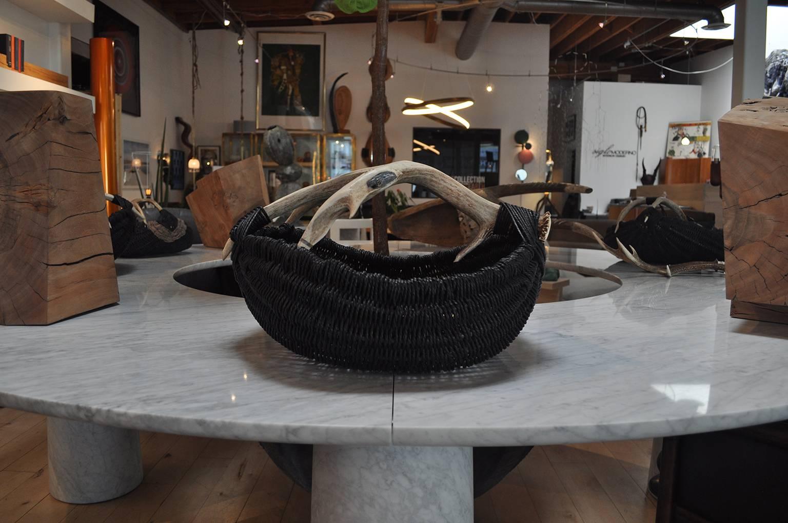 This large scale hand-made, custom, shed deer antler with an embedded blue kyanite stone, reed and Danish paper rope basket, is made by Los Angeles based Artist and Designer, Dax Savage. Having learned the art of antler basket weaving from his