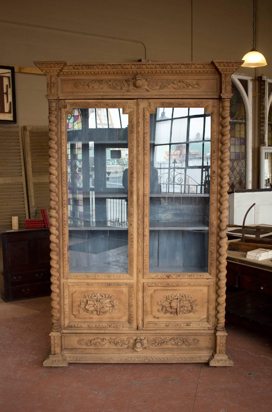 Beautiful French stripped carved oak bibliotheque or library cupboard in the Renaissance Revival style, It has plenty of shelves for books or perhaps crockery and glasses. Single drawer to the bottom spans the width of the glazed doors. Lovely