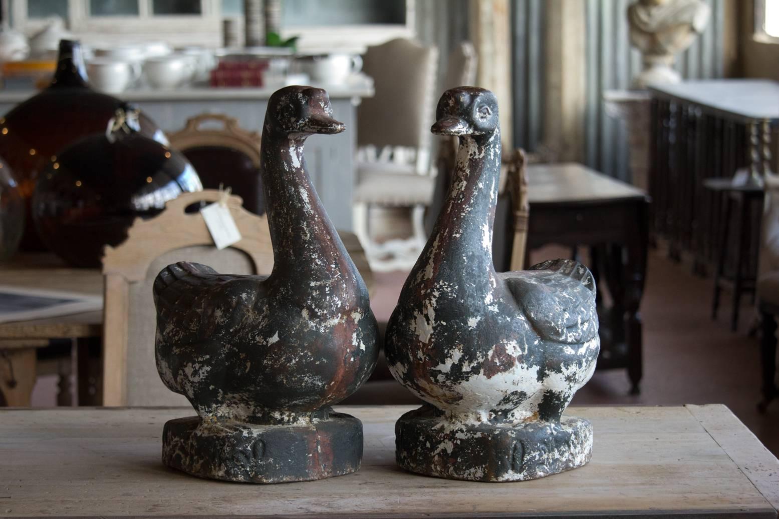 Pair of substantial vintage English cast iron ducks with original distressed paint. Tons of character.