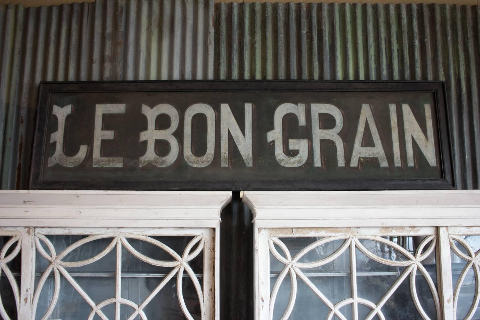 Vintage Belgian metal Industrial baker's sign, Le Bon Grain, from Haine Saint Pierre. It is hand-painted and framed in wood. Great size and color. Perfect wall art.