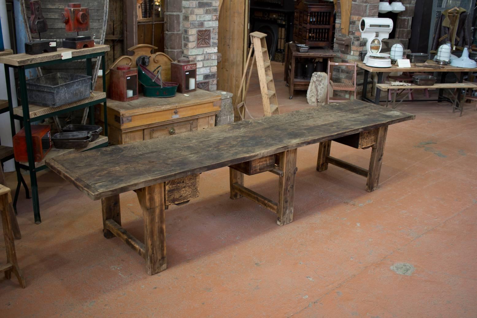 This is a very substantial and meaty antique Industrial work table with three deep drawers. Fantastic patina.