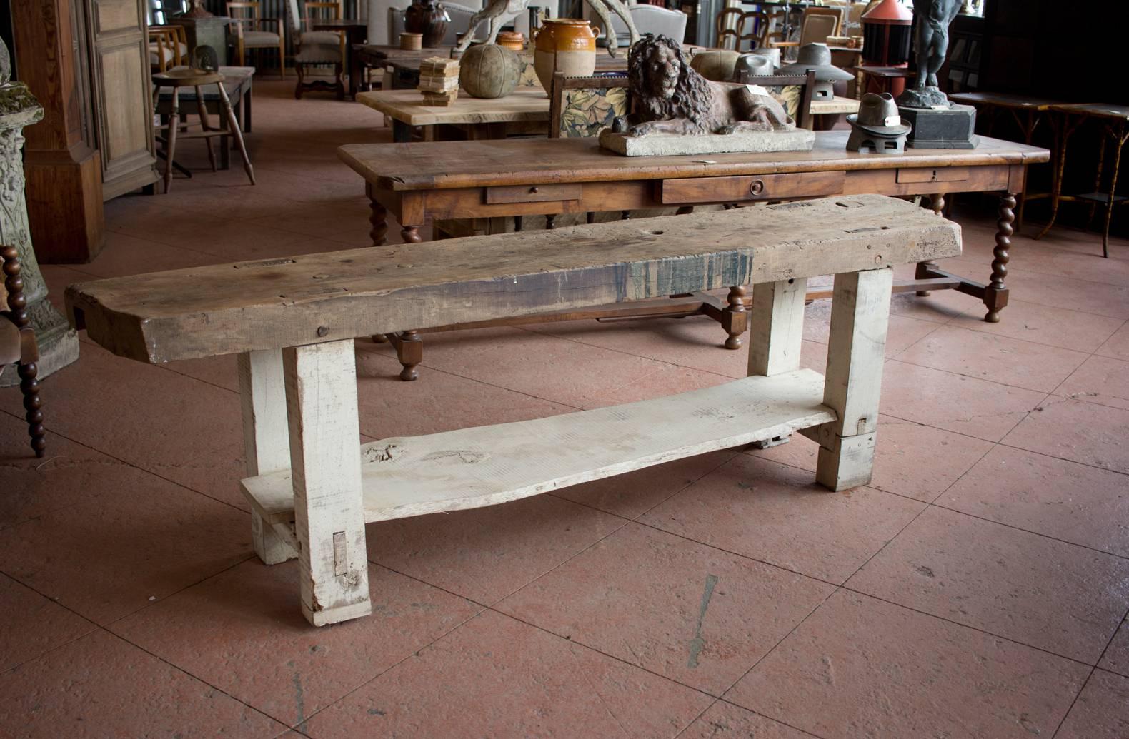Wonderful substantial 19th century French workbench with a live edge shelf.