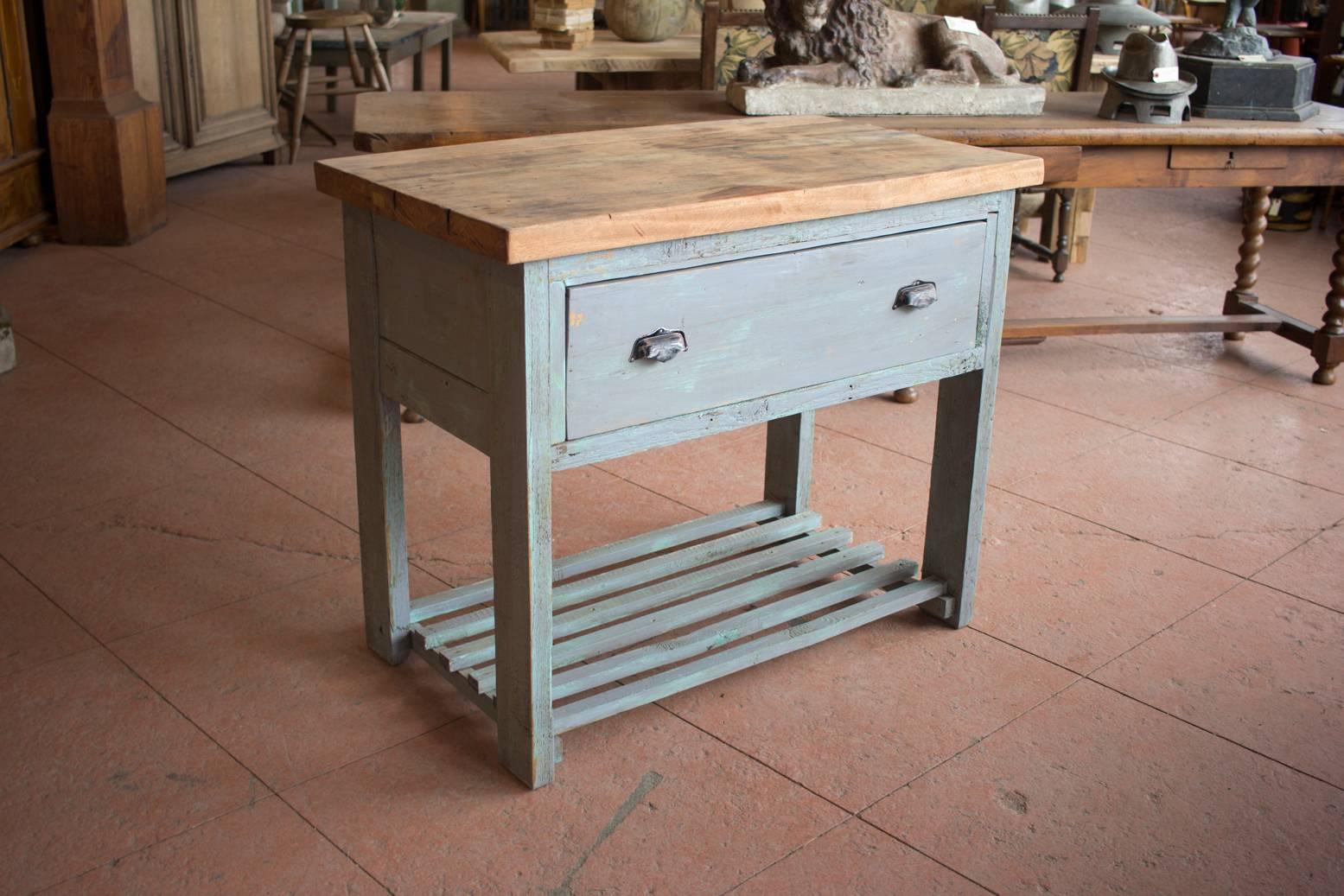 Vintage French kitchen work table with a chopping board top, deep drawer and slatted lower shelf.