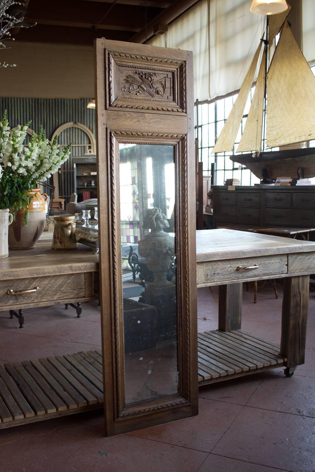 An original 18th century Louis XVI French oak mirror with original mirror and with carved cornucopia (Horn of plenty) design.