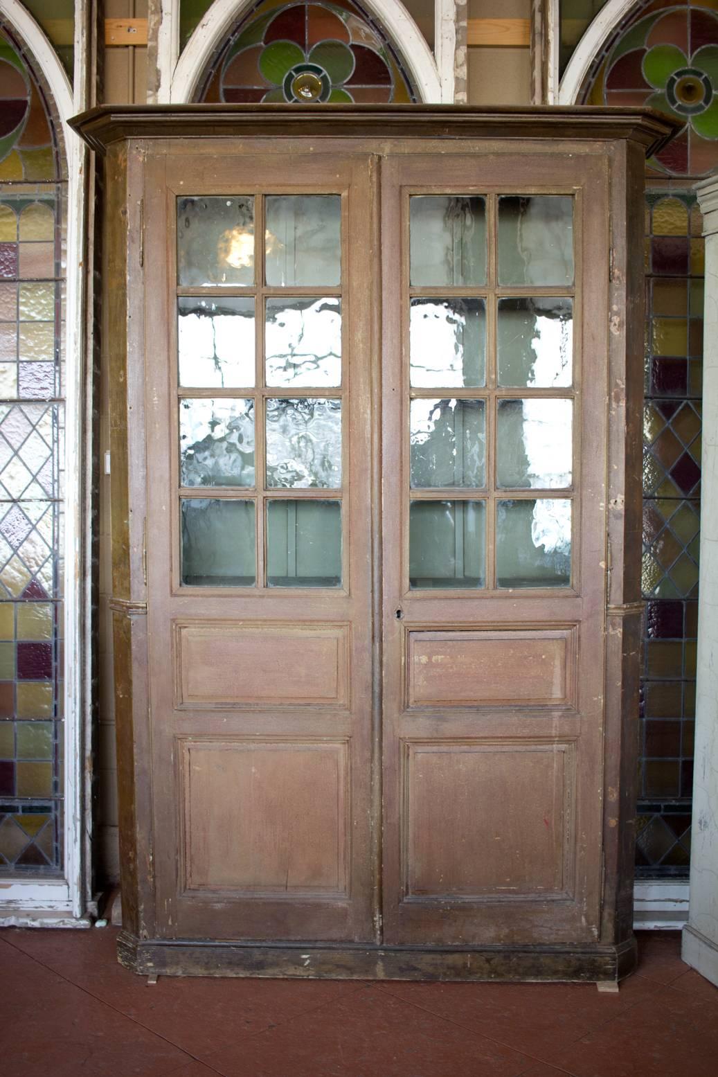 Antique French Louis Philippe bibliotheque/library with its original paint and beautiful original wavy glass.

Width is 67 inches with the top moulding and 60 inches below the moulding.