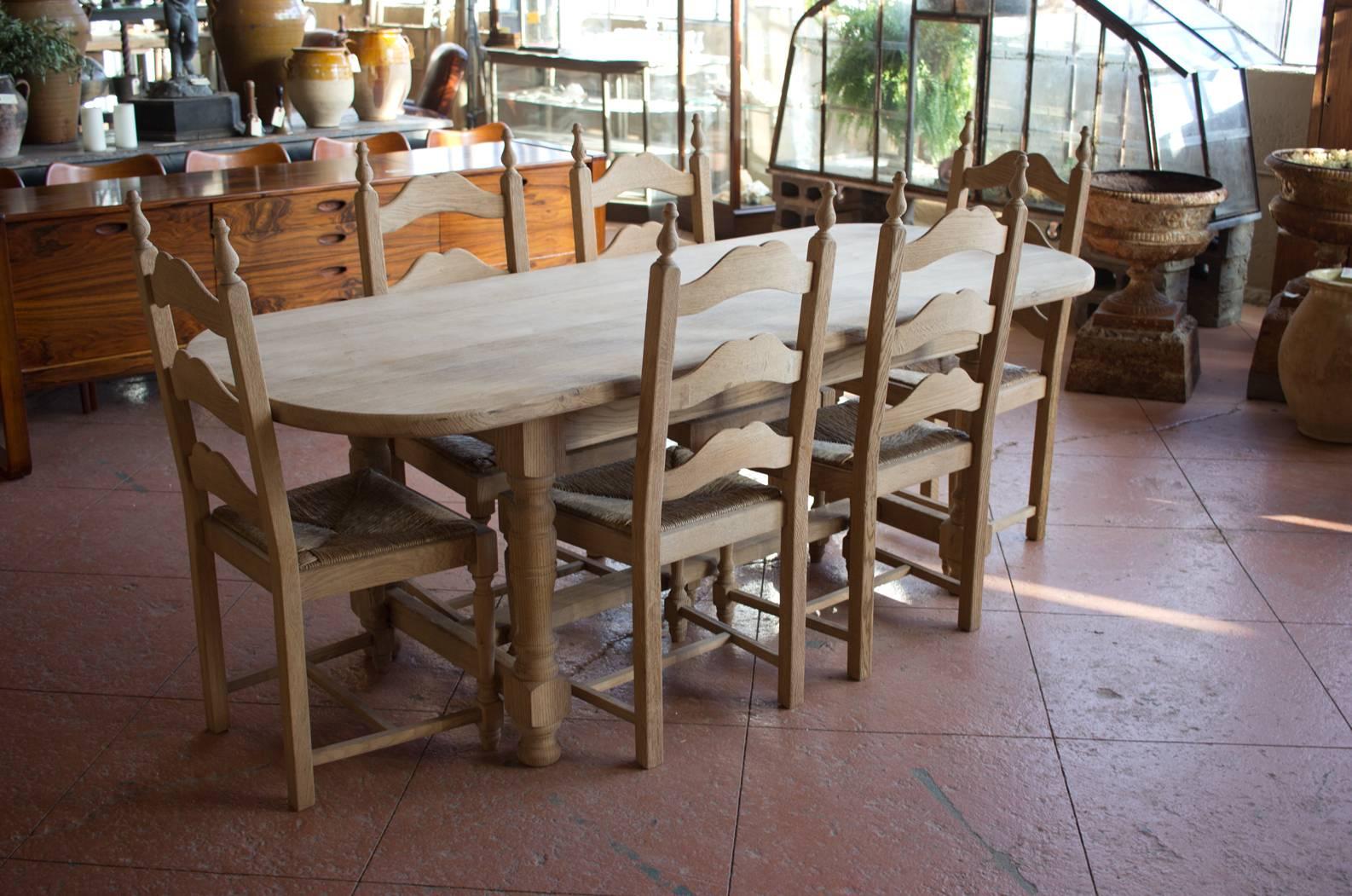 Fabulous quality French vintage stripped oak oval table with six rush seat ladder back chairs. Works beautifully with the French stripped oak buffet a deux corps listed.

Table dimensions: 30.0" tall x 84.0" long x 34.0"