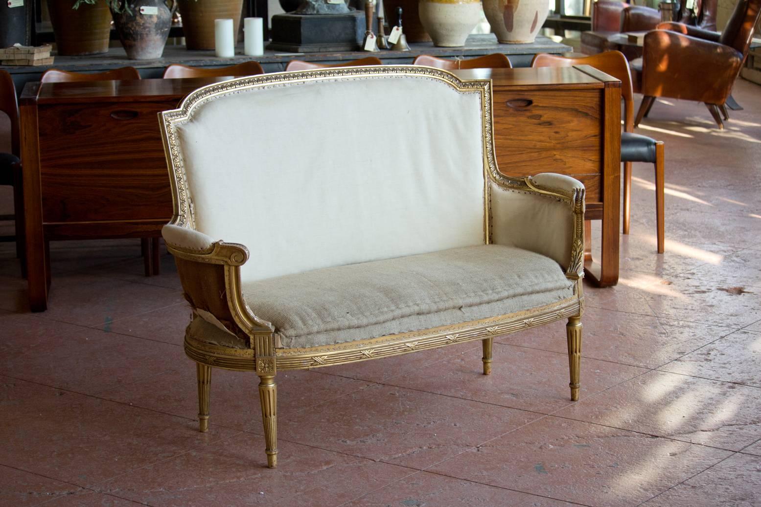 Antique Louis XVI petite bergère settee with original gilded frame.