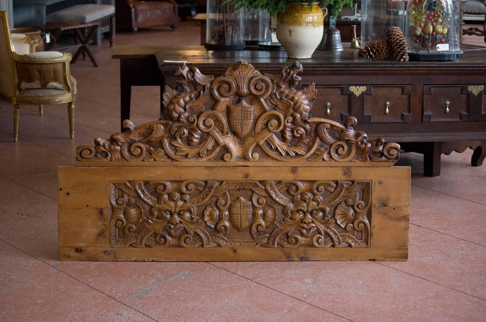 Large antique Burgundian pine carving with wonderful detailing of armorial crests, Green Men, dragons, acanthus leaves and anthemions. Beautiful color.