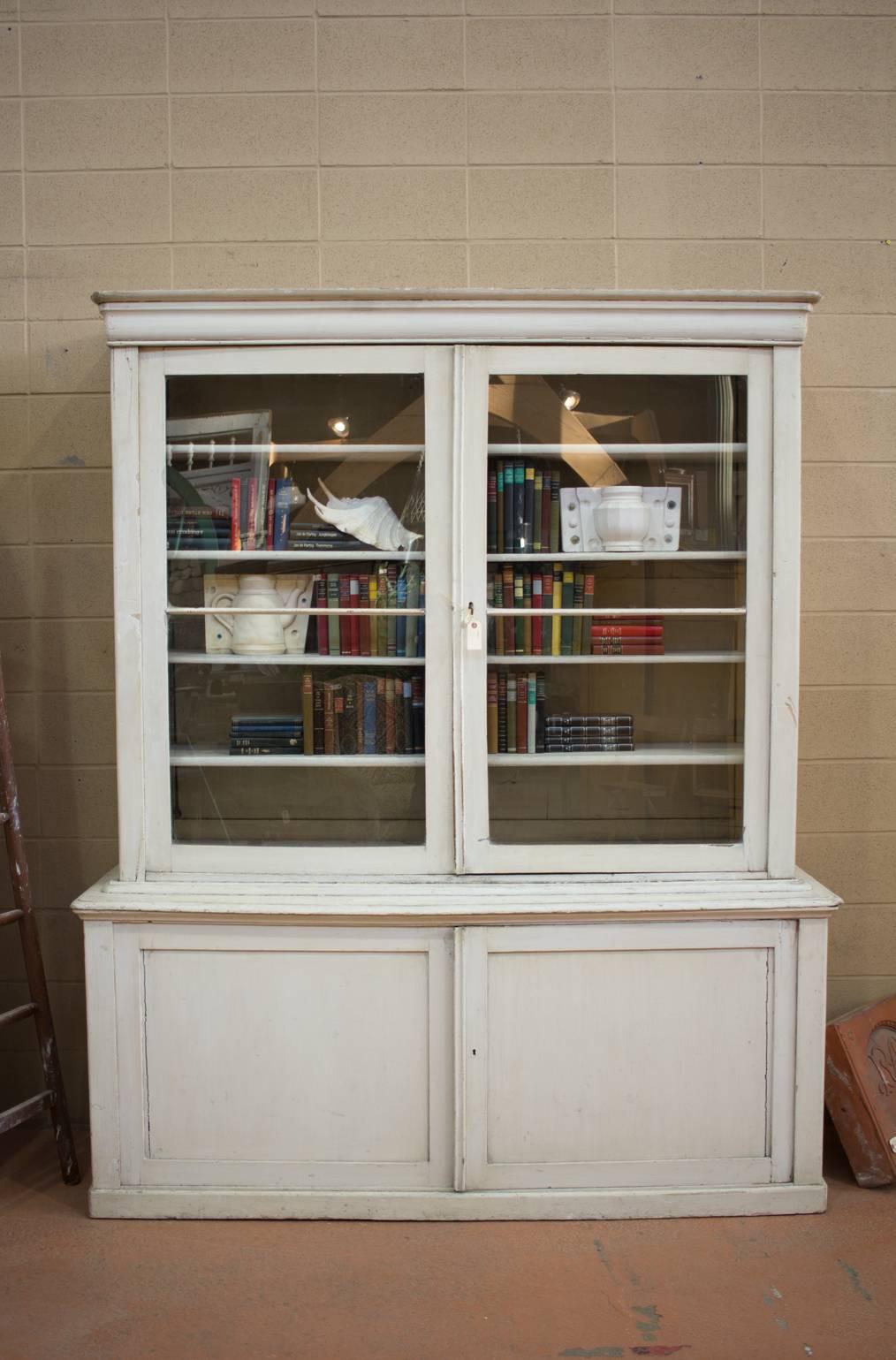 Substantial antique English country-house painted library Bibliotheque. Plenty of upper and lower storage. Would work well in a library or in a kitchen for crockery and glassware.