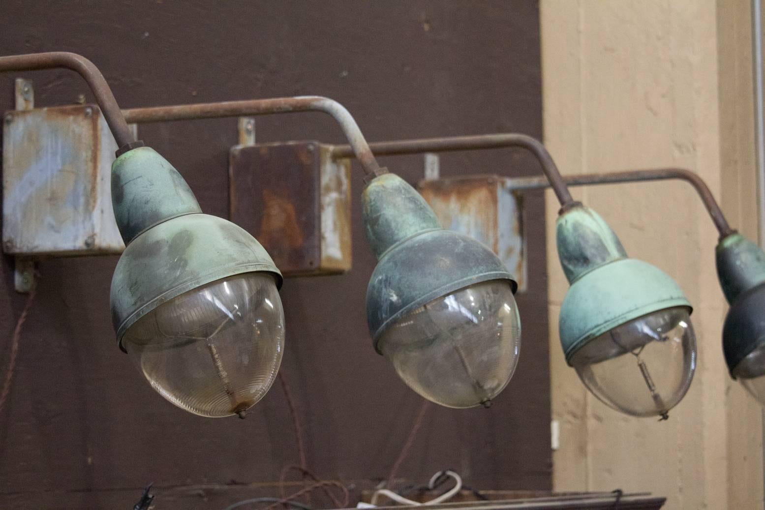 Rare vintage Industrial French copper and Holophane glass wall light. We currently have six available.